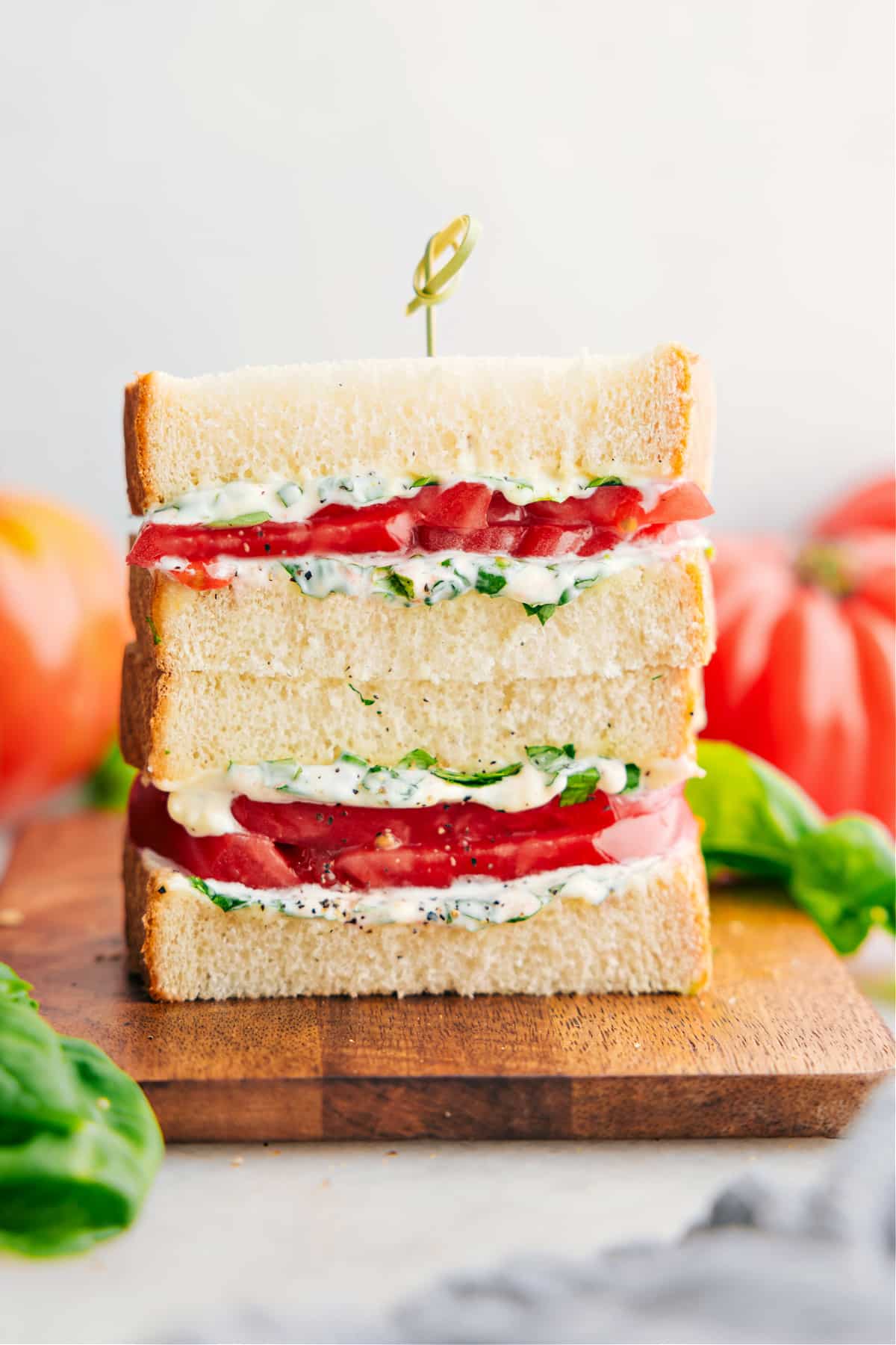 The Best Tomato Sandwich Recipe Tomato Sandwich stacked on top of each other showing the delicious inside.