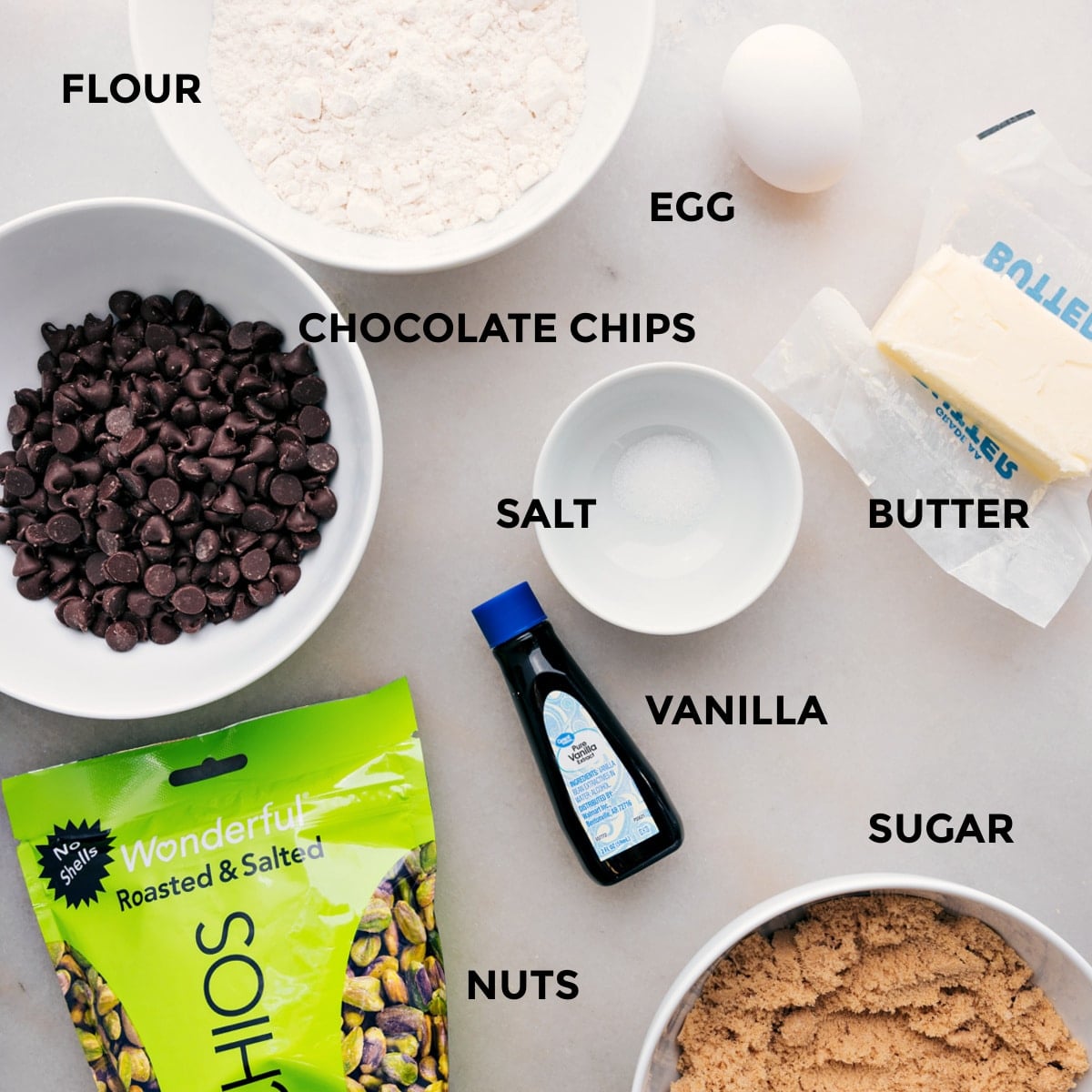 Ingredients In This Blondie Recipe All the ingredients including flour, salt, butter, vanilla, sugar, pistachios, chocolate chips, and an egg prepped out for easy assembly.