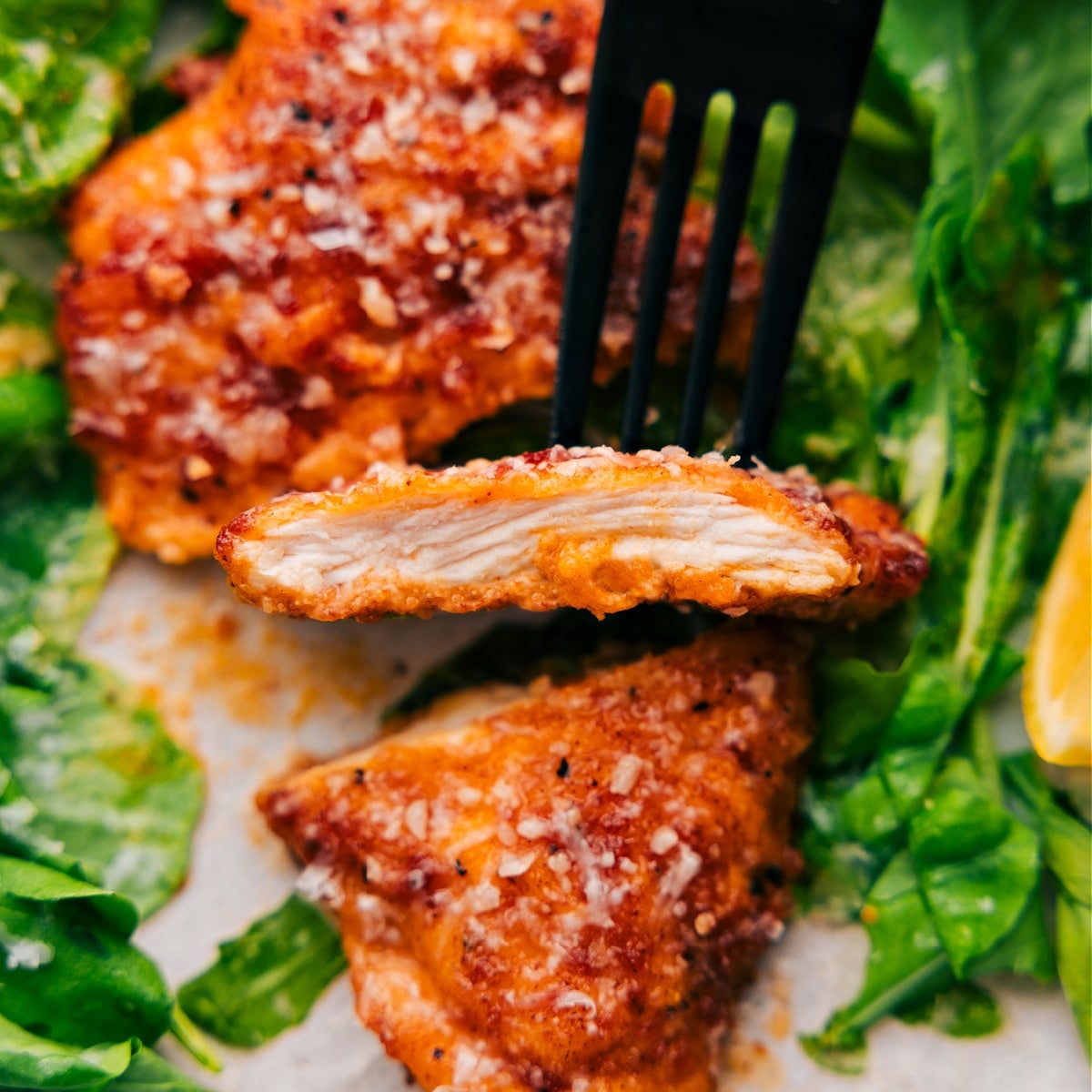 The Best Weeknight Dinner: Chicken Cutlets A slice of the chicken cutlet is held up with a spoon, showing its tender and perfectly cooked inside.