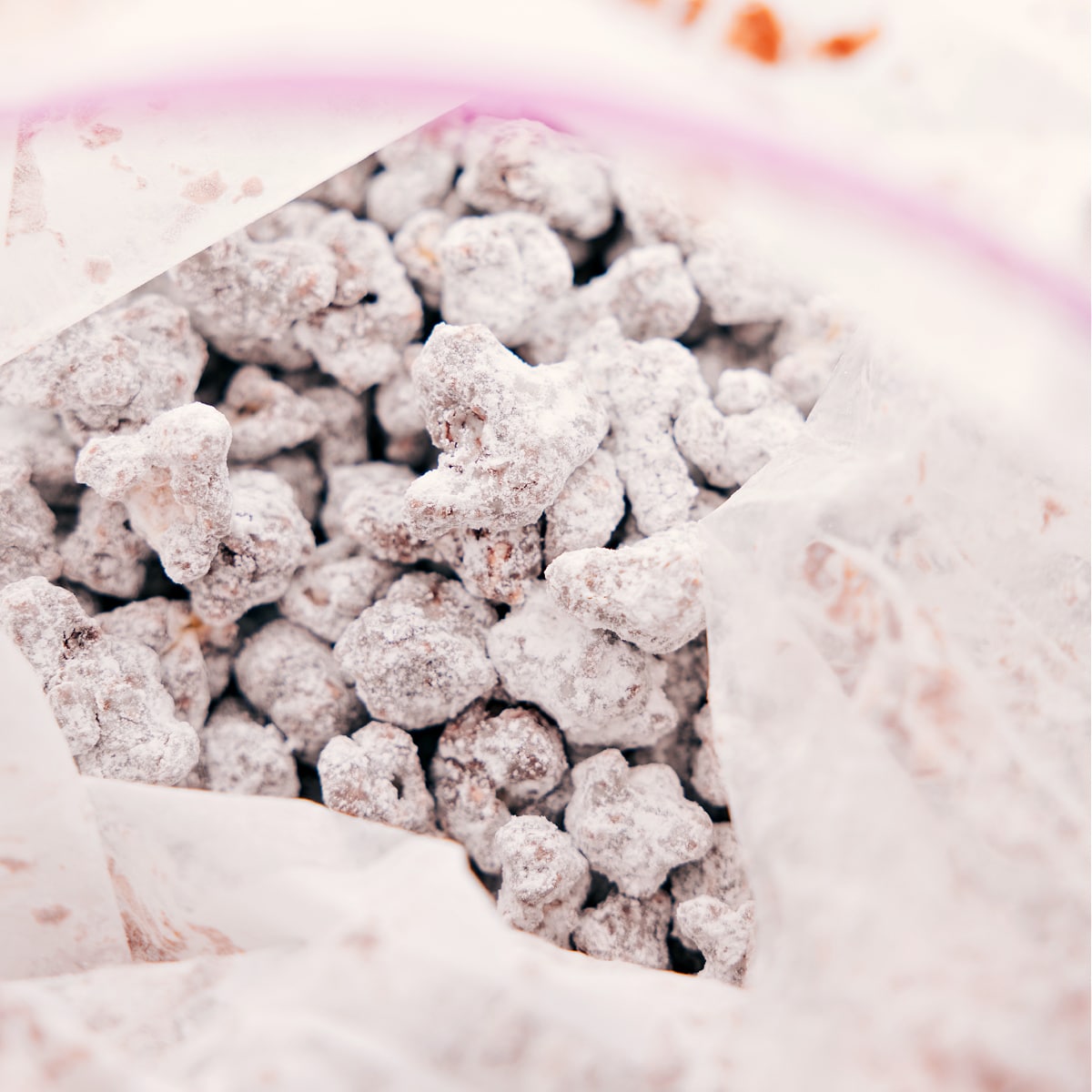 Toss Popcorn Puppy Chow In Powdered Sugar Toss the snack mix in a bag with powdered sugar to coat everything evenly.