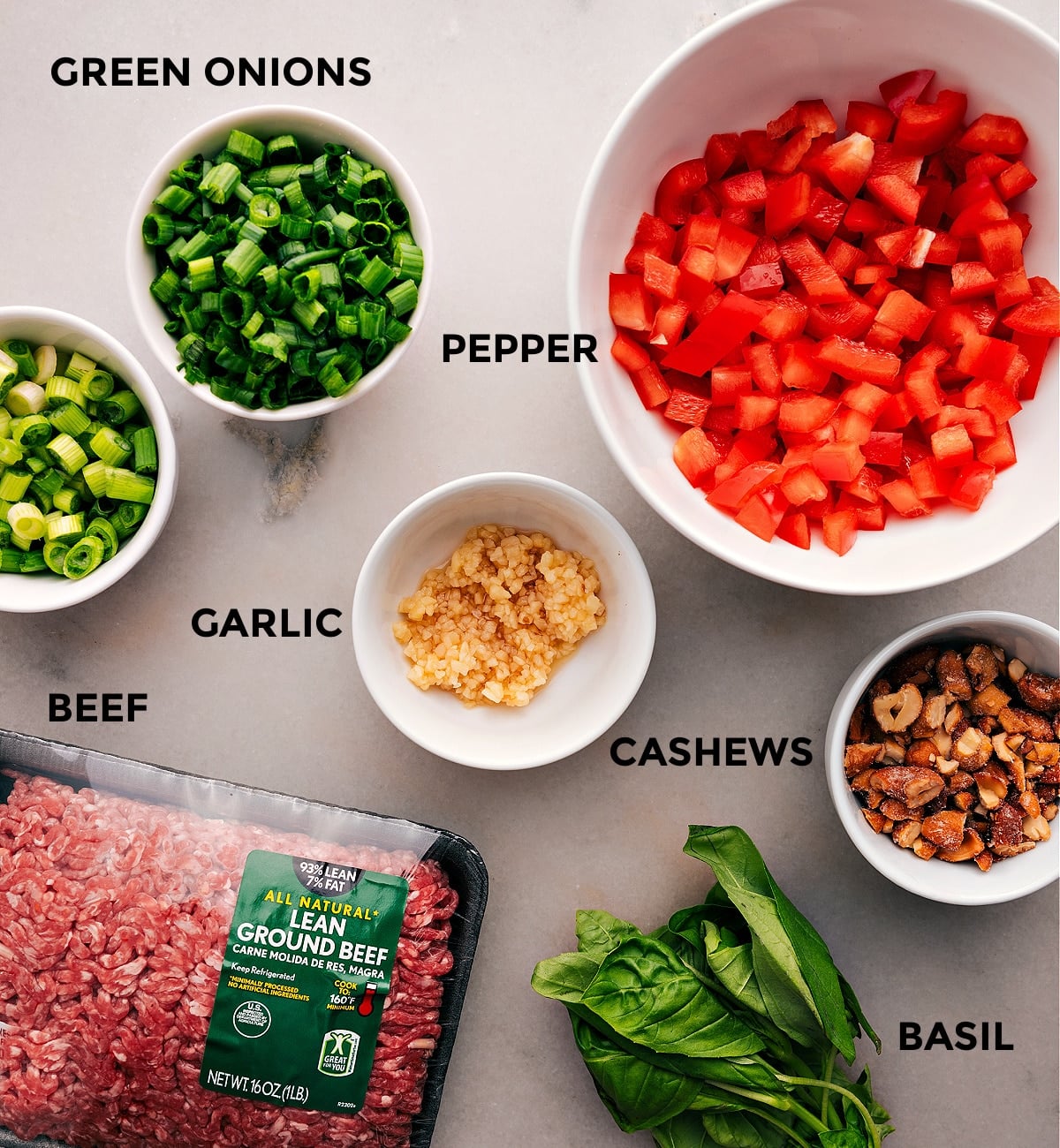 Ingredients In Asian Ground Beef All the ingredients for this recipe are prepped and ready for easy assembly, including peppers, garlic, meat, cashews, and basil.