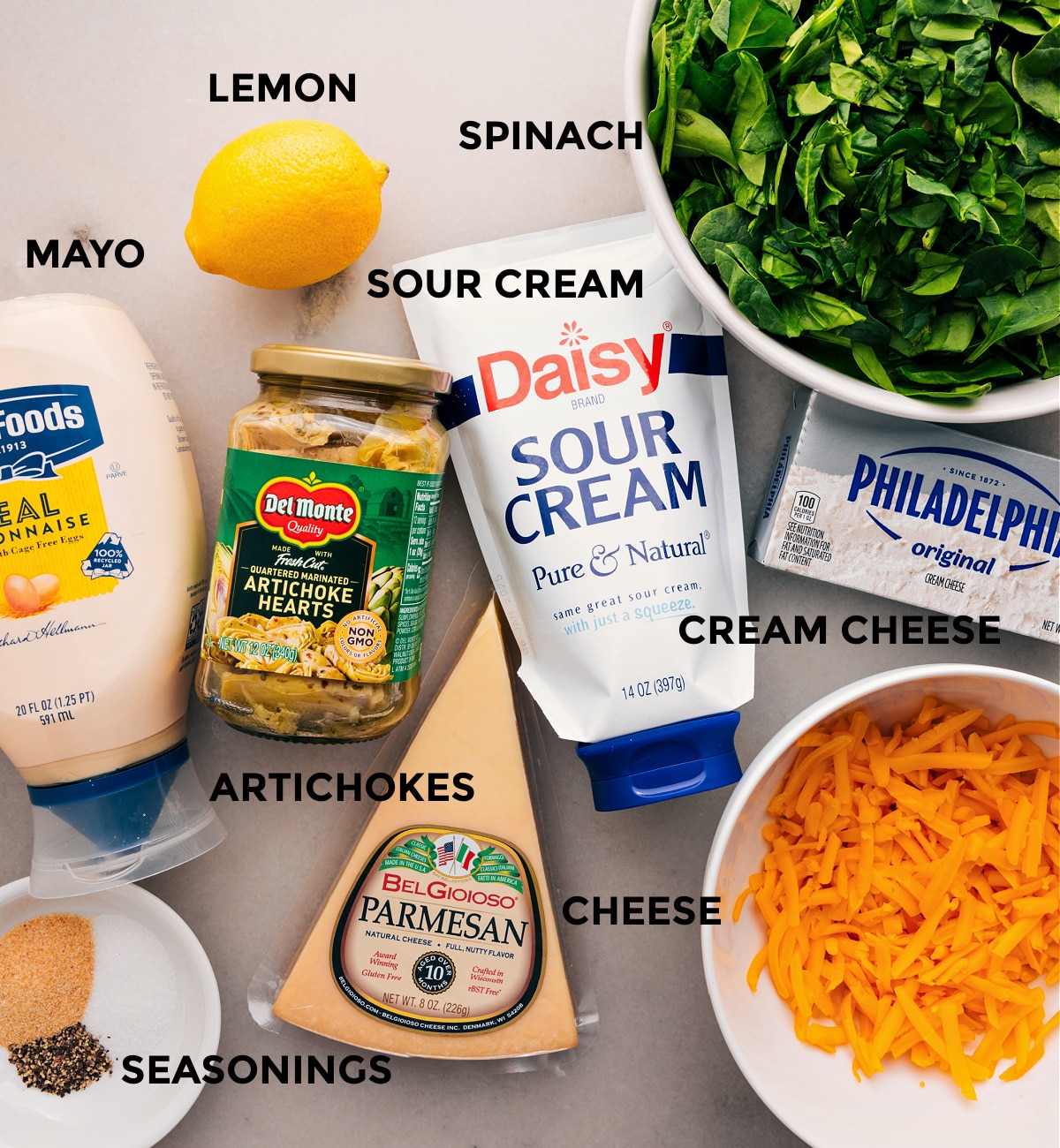 Ingredients In Spinach Artichoke Dip All the ingredients for this recipe are prepped and ready for easy assembly: veggies, lemon, cream cheese, mayo, cheese, and seasonings.