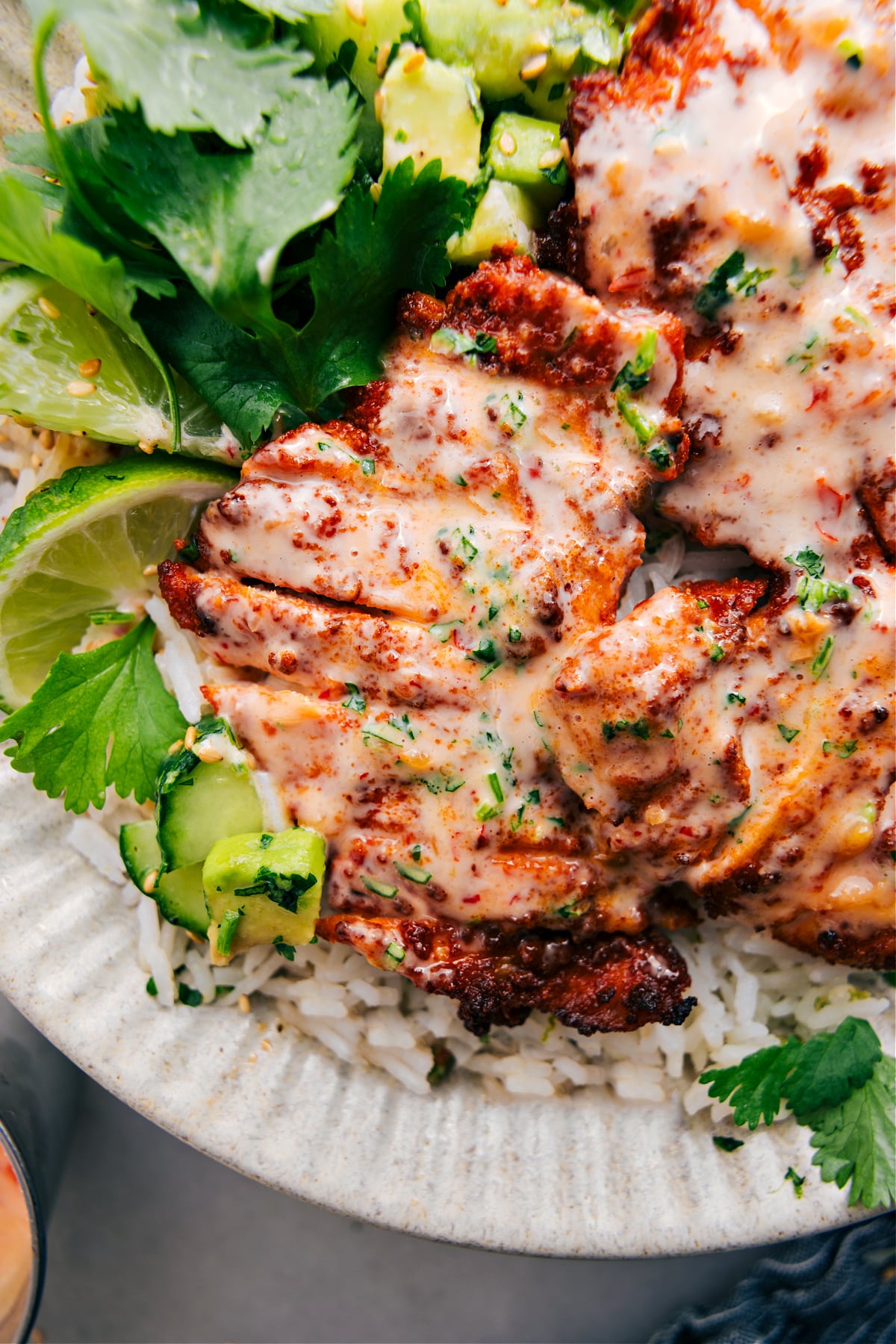 Citrus Bang Bang Chicken Recipe Bang Bang Chicken served on a bed of rice, topped with Bang Bang sauce and a sprinkle of lime zest.