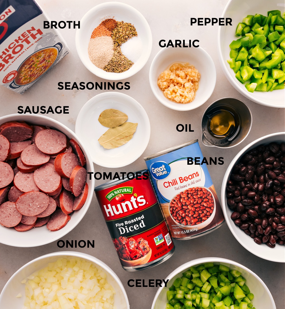 Ingredients In Black Beans And Sausage Over Rice Dish All the ingredients for this recipe are prepped and ready for easy assembly: meat, broth, seasonings, peppers, oil, beans, and tomatoes.