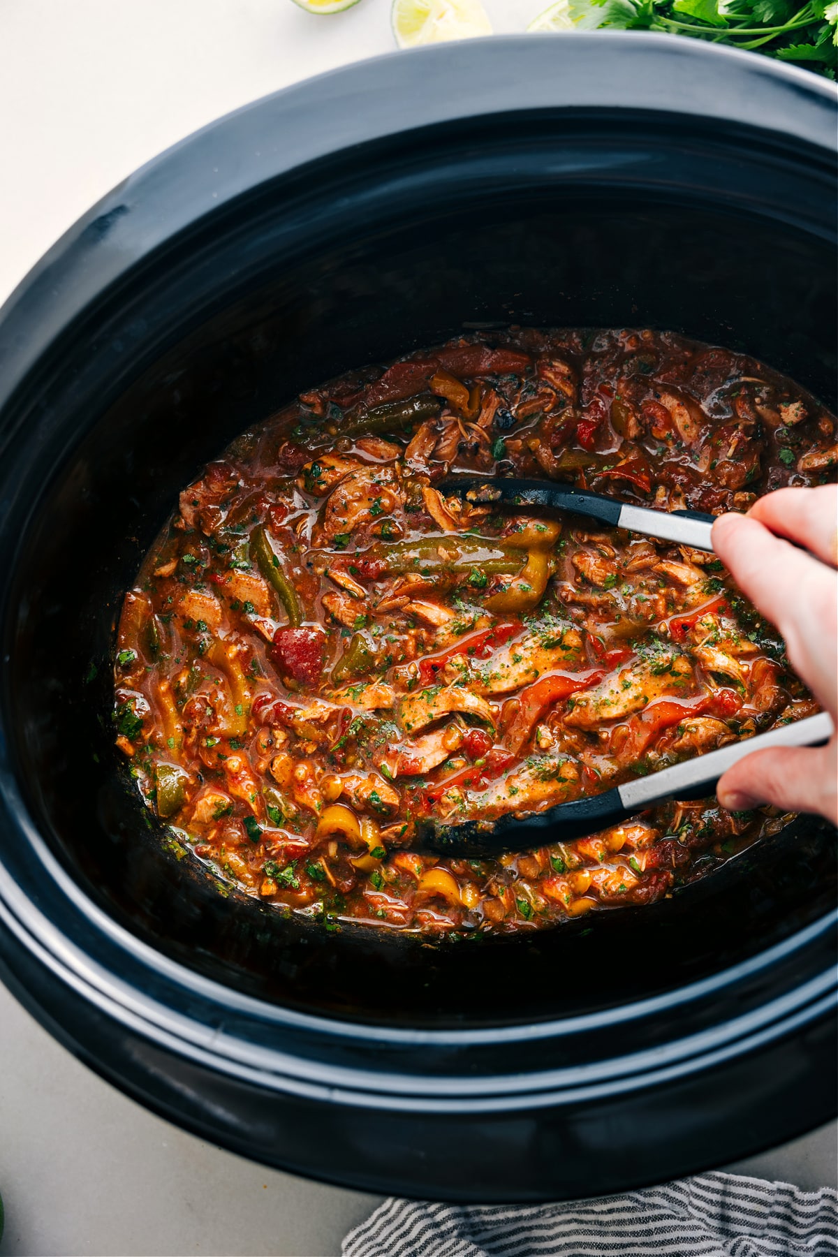 The Best Crockpot Chicken Fajitas Crockpot Chicken Fajitas cooked in the slow cooker. Use tongs to serve.