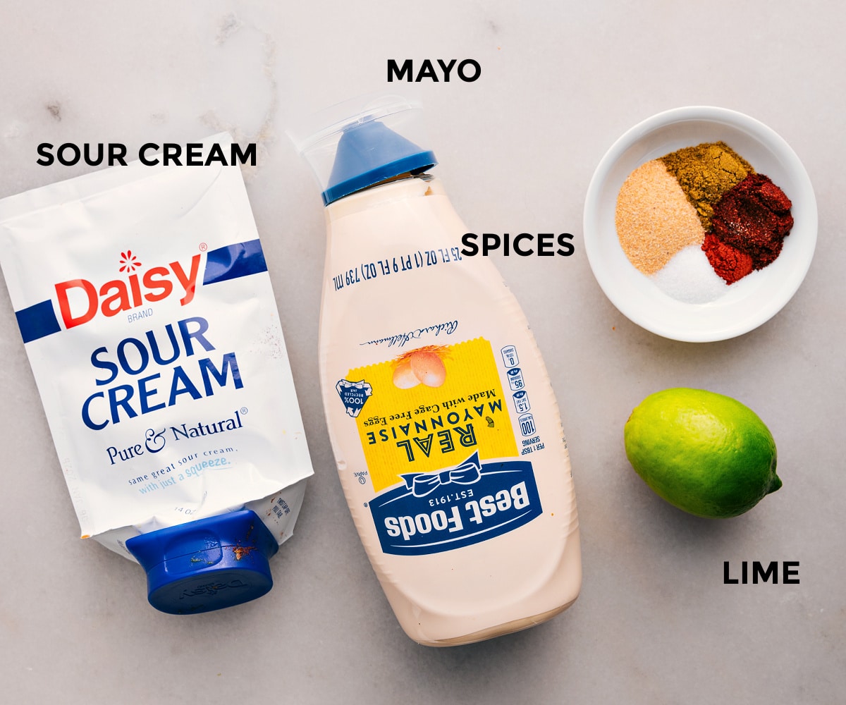 The Best Dressing For Southwest Chicken Salad Dressing ingredients prepped for easy assembly in this Southwest Chicken Salad recipe: sour cream, mayo, spices, and lime.