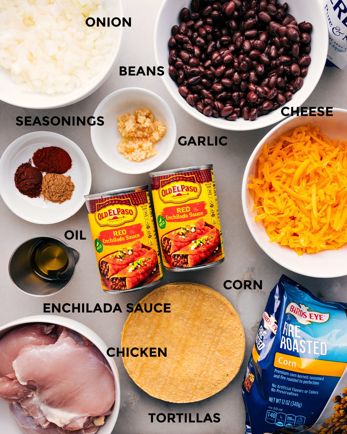 Ingredients In Crockpot Chicken Enchilada Casserole All the ingredients in this recipeโbeans, sauce, cheese, tortillas, corn, seasonings, veggies, and meatโare prepped for easy assembly.
