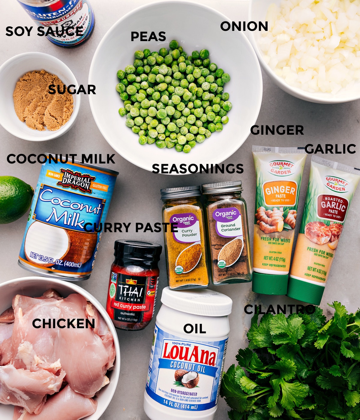 Ingredients In Crockpot Curry Chicken All the ingredients are prepped for easy assemblyโpeas, onion, garlic, ginger, seasonings, soy sauce, sugar, coconut milk, red curry paste, meat, oil, and cilantro.