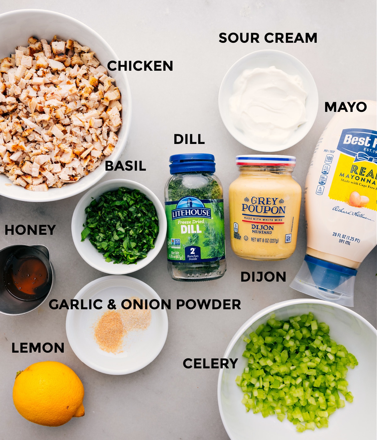 Ingredients In Lemon Basil Chicken Salad All the ingredients for this recipe are prepped and ready for easy assembly, including the meat, mayo, sour cream, dijon, herbs, celery, lemon, and honey.