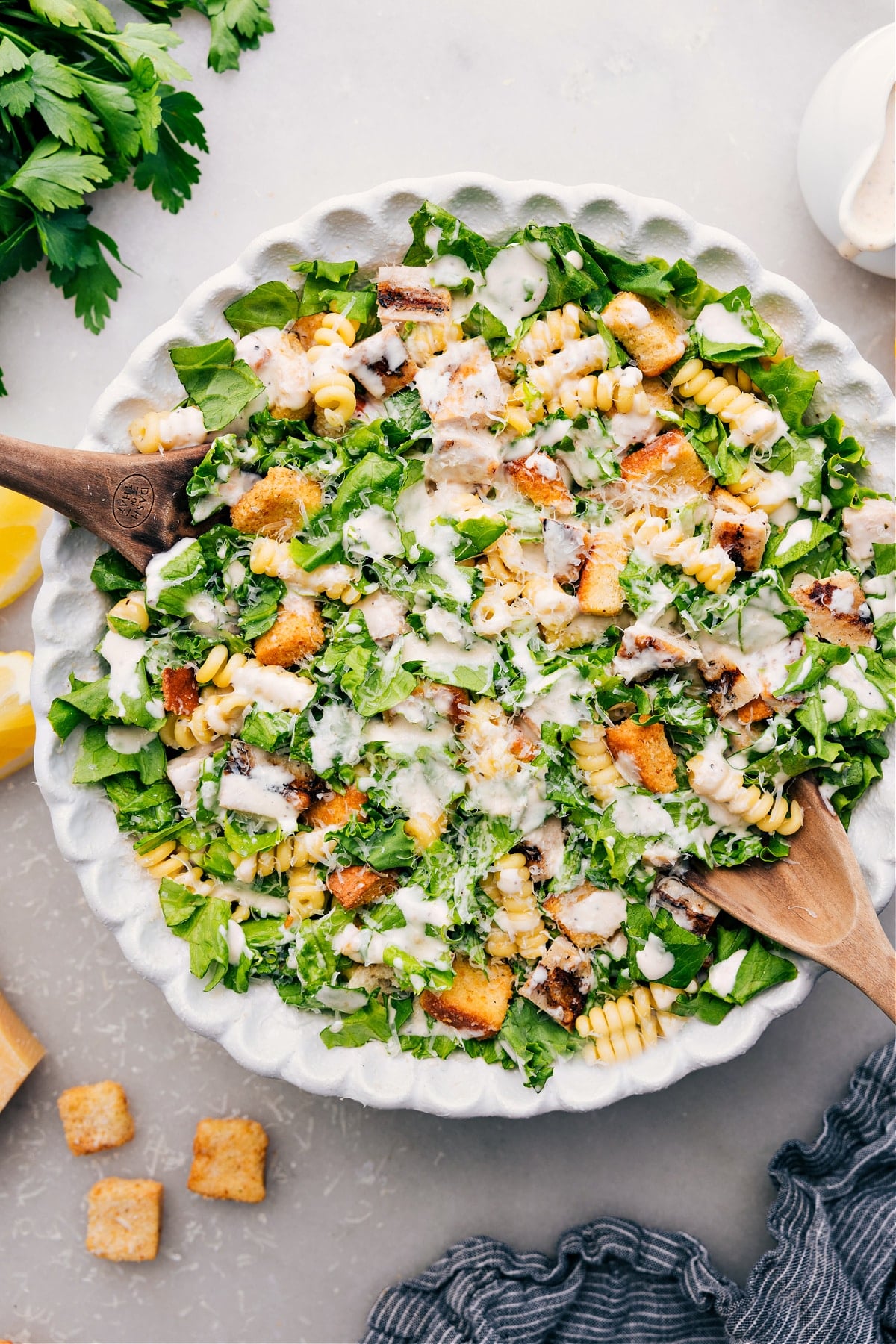 The Best Chicken Caesar Pasta Salad Recipe Chicken Caesar Pasta Salad in a bowl, topped with dressing, ready to be served and enjoyed.