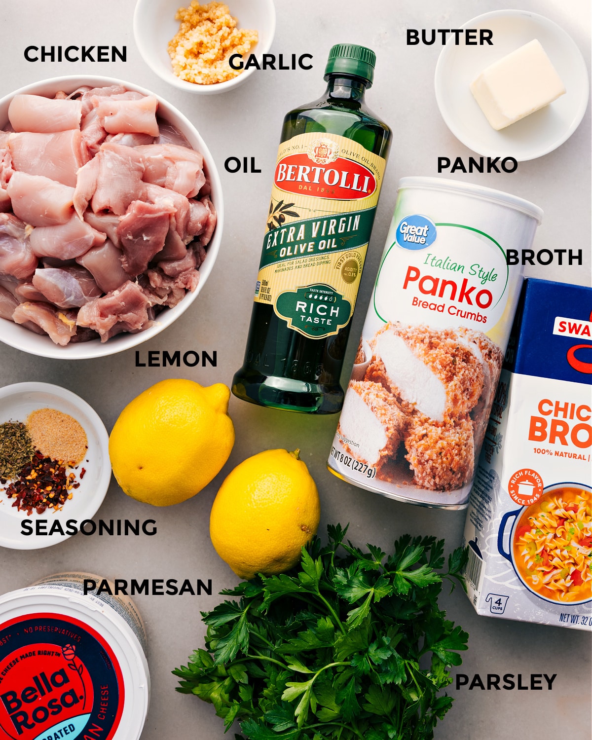 Ingredients In Chicken Spiedini All the ingredients are prepped for easy assemblyโmeat, oil, panko, butter, garlic, broth, lemon, seasoning, parmesan, and parsley.