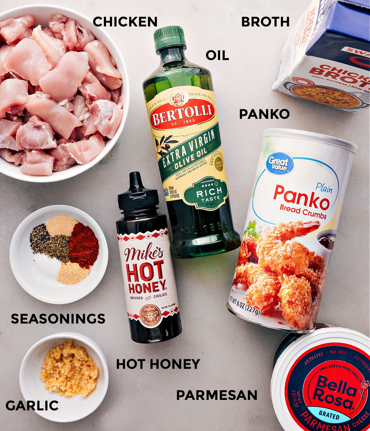 Ingredients In Hot Honey Chicken This recipe starts with everything prepped for easy assemblyโmeat, broth, panko, oil, honey, seasoning, parmesan, and garlic.