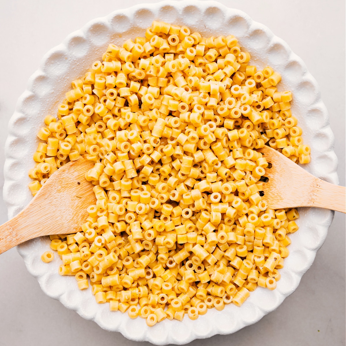 How To Make Italian Grinder Pasta Salad Cooked pasta sits in a bowl, ready to toss with the other ingredients for this Italian Grinder Pasta Salad.