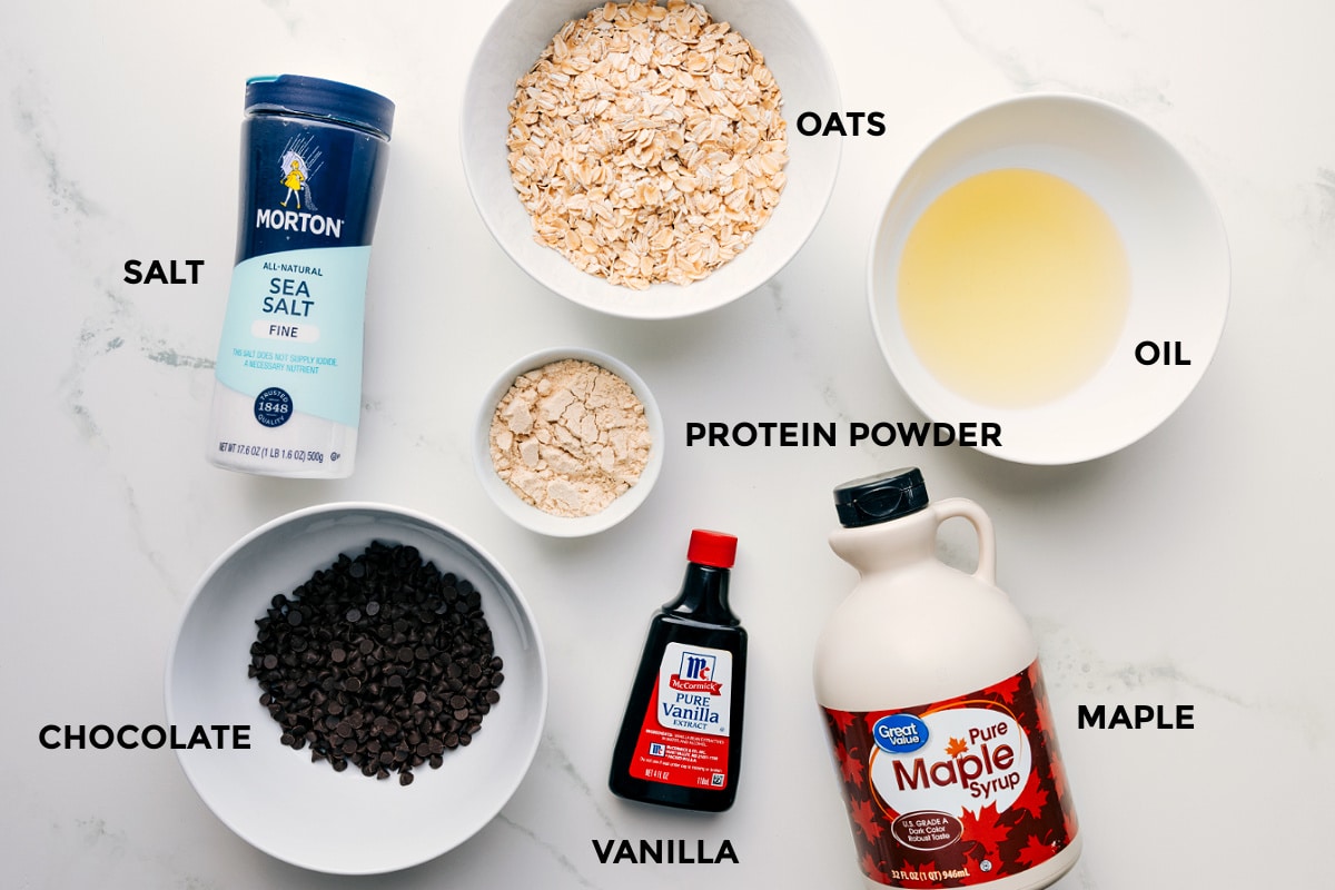 Ingredients In Protein Cookie Dough All the ingredients for this recipe, prepped and ready for easy assembly: oats, oil, salt, protein powder, vanilla, maple syrup, and chocolate.