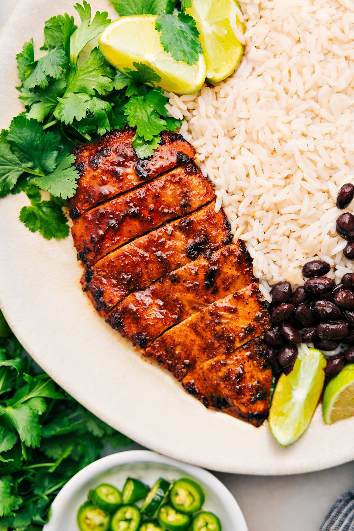 Southwest Chicken on a plate with rice and beans.