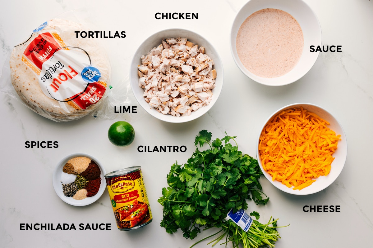 Ingredients In Baked Chicken Tacos All the ingredients for this recipe prepped and ready for easy assembly, including chicken, sauce, cheese, cilantro, enchilada sauce, spices, tortillas, and limes.