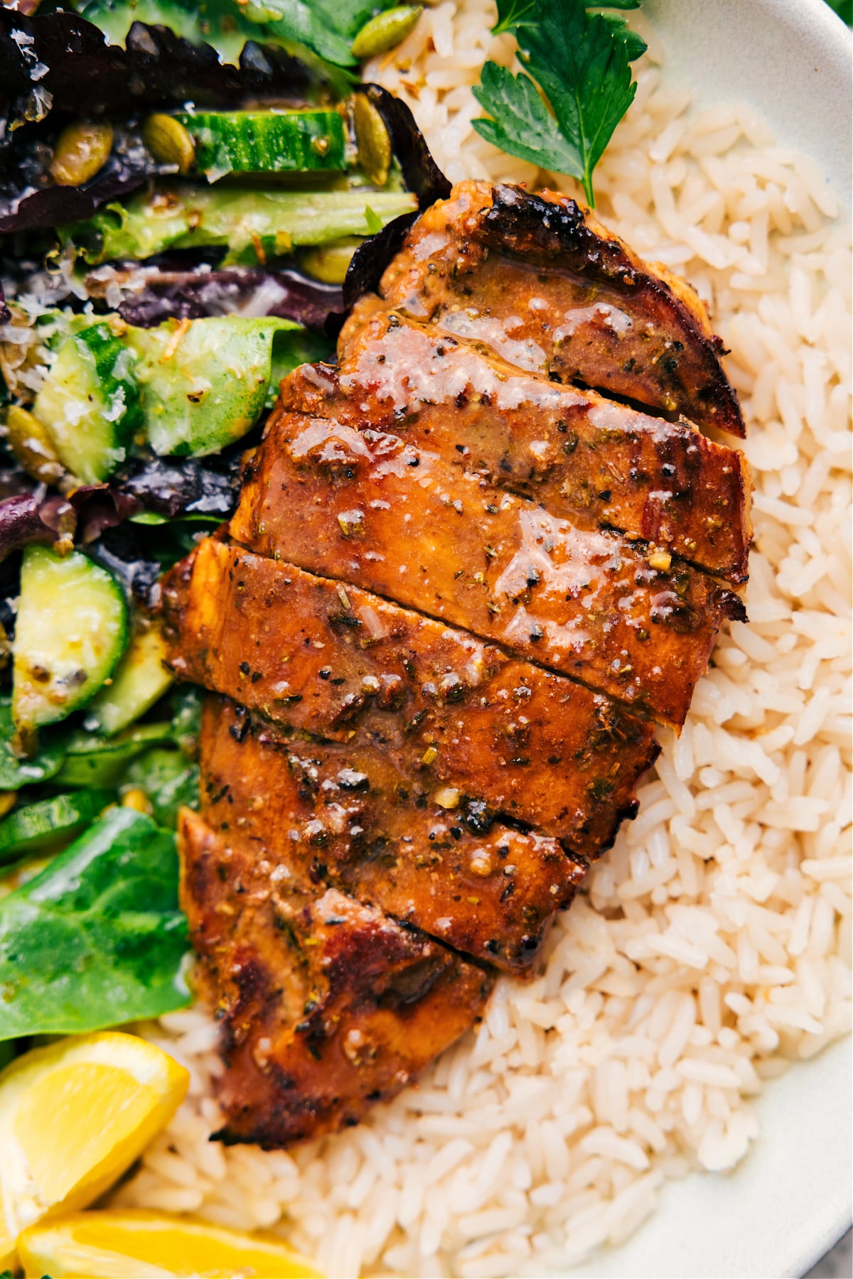 Balsamic Chicken Marinade served over a bed of rice with a fresh side salad, ready to enjoy.