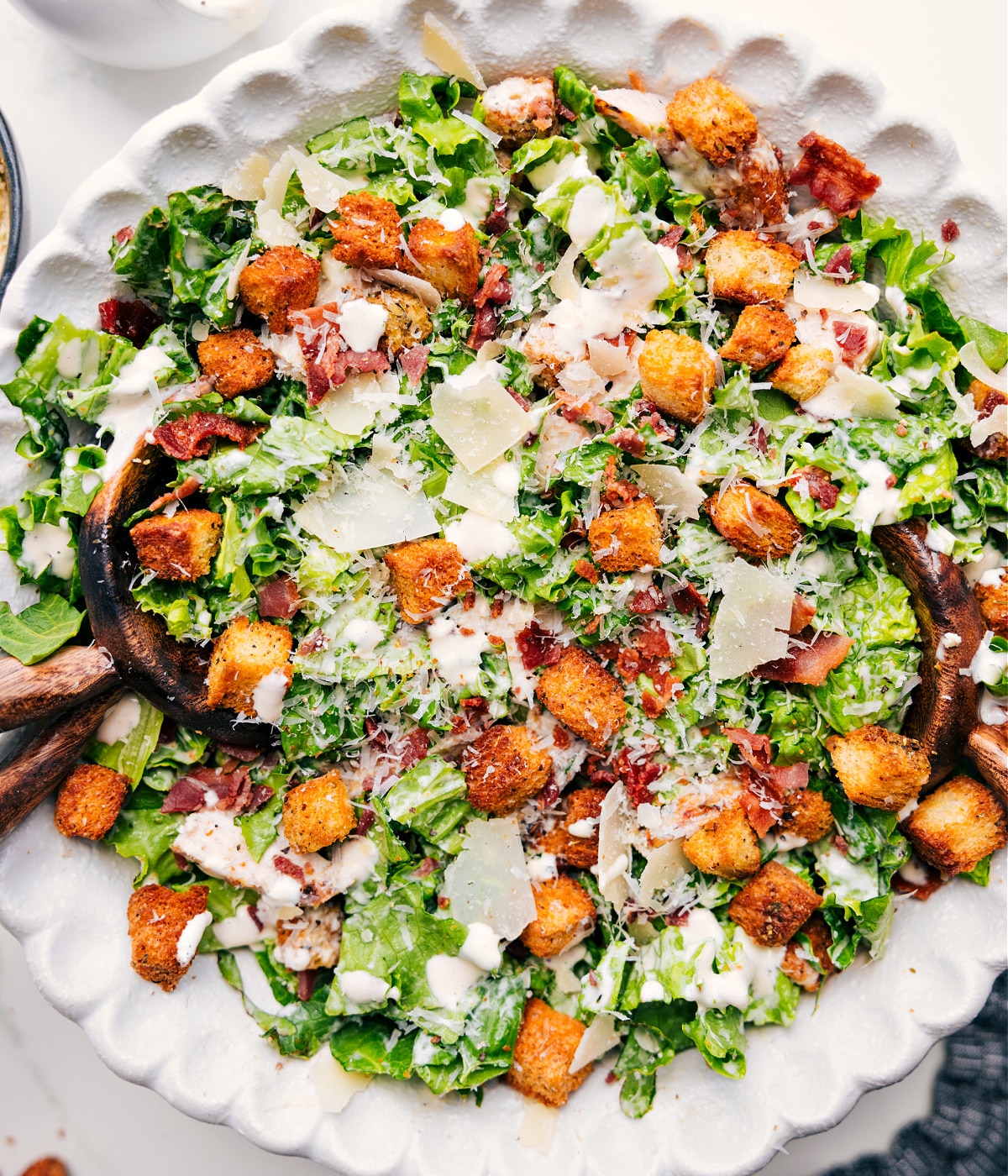 Caesar Salad Dressed With Caesar Dressing Recipe A salad tossed with the dressing and topped with all the delicious extras for a satisfying dinner.