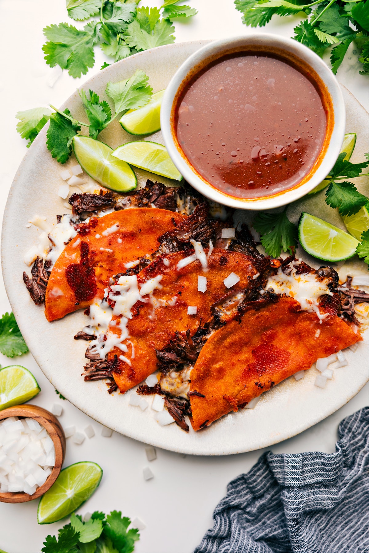 The Best Quesabirria Recipe Quesabirria served with a side of consomรฉ dip.