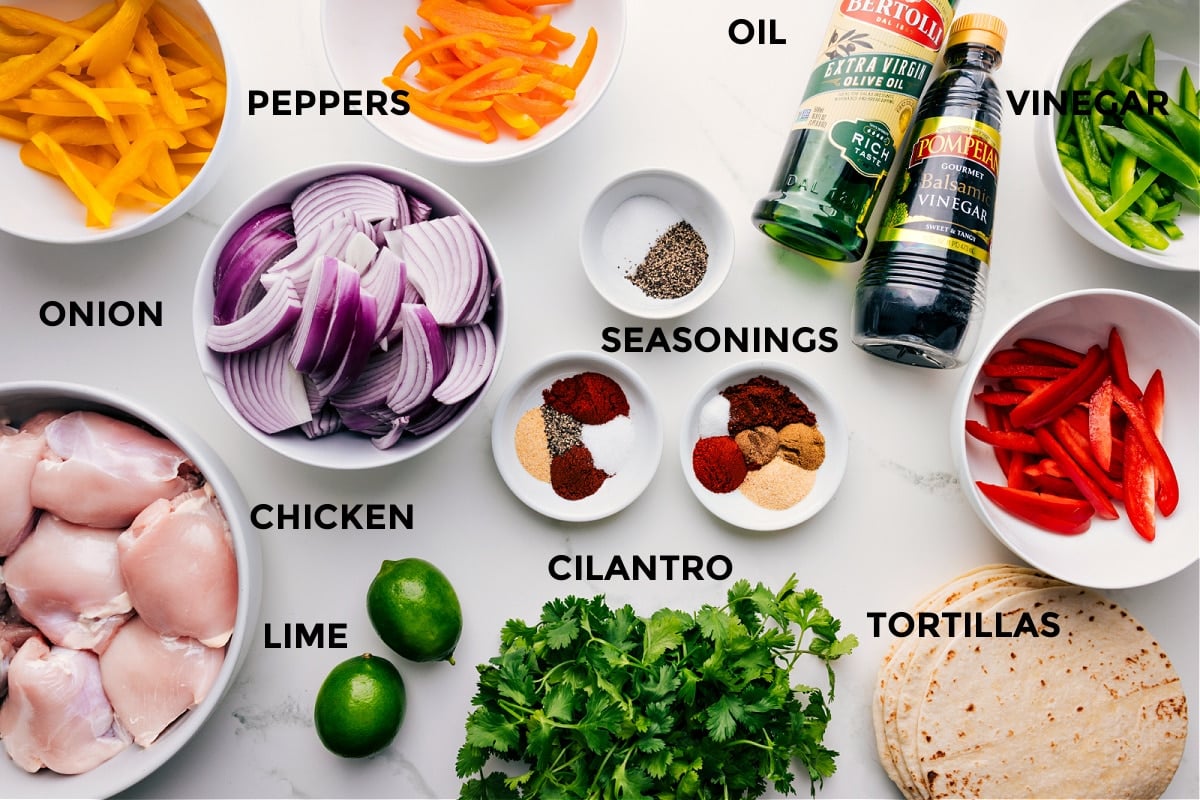 Ingredients In Sheet Pan Chicken Fajitas All the ingredients for this recipe prepped for easy assembly, including peppers, onions, seasonings, balsamic vinegar, olive oil, and tortillas.ilantro, chicken, and limes.
