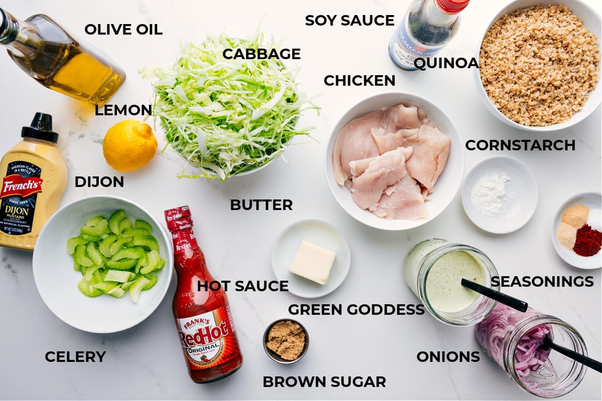 Ingredients In Buffalo Chicken Bowl All the ingredients prepped for easy assembly, including olive oil, cabbage, chicken, soy sauce, quinoa, cornstarch, seasonings, dressing, onions, butter, hot sauce, celery, Dijon, and lemon.