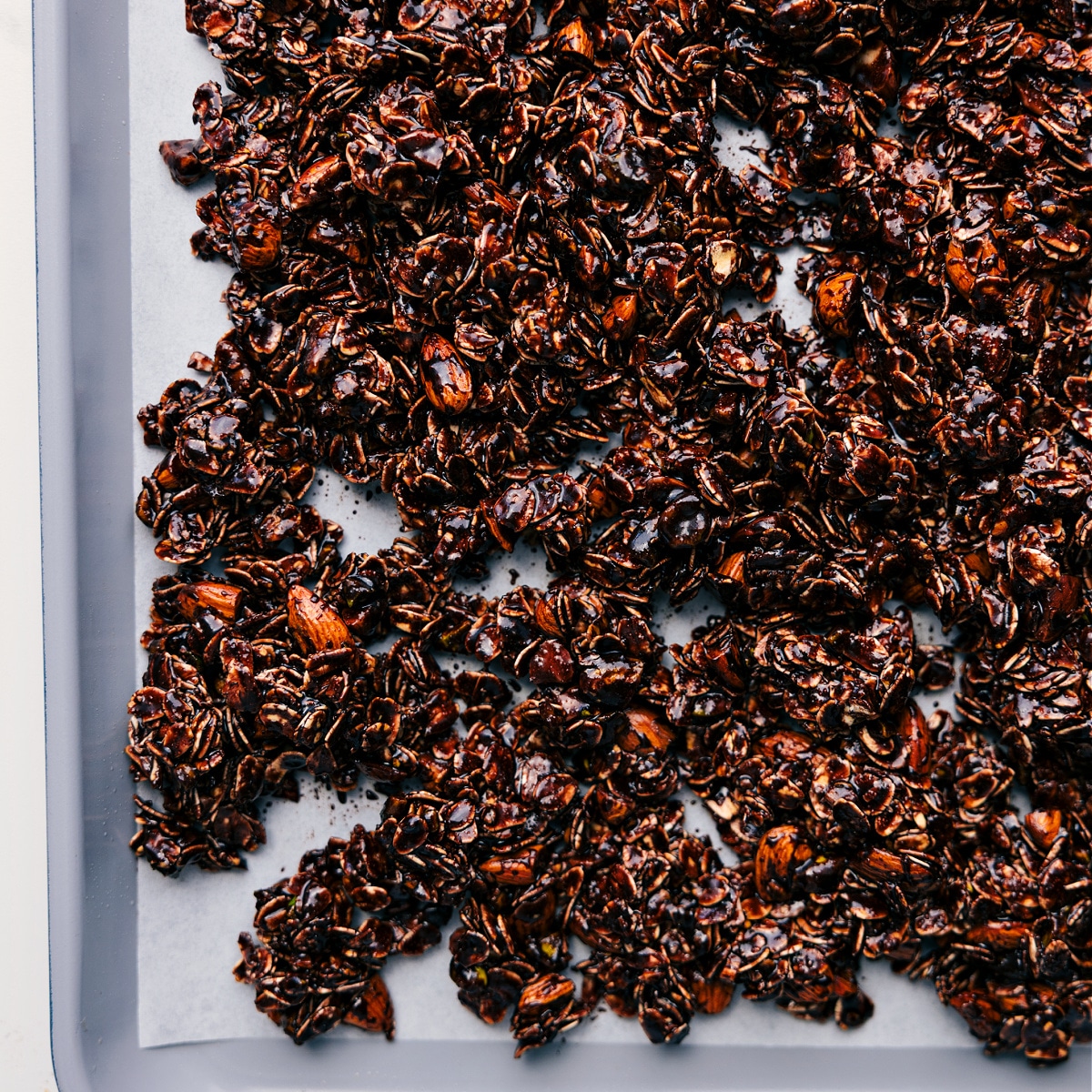 The Perfect Chocolate Granola Recipe The mixture is spread onto a baking sheet, ready to be baked.