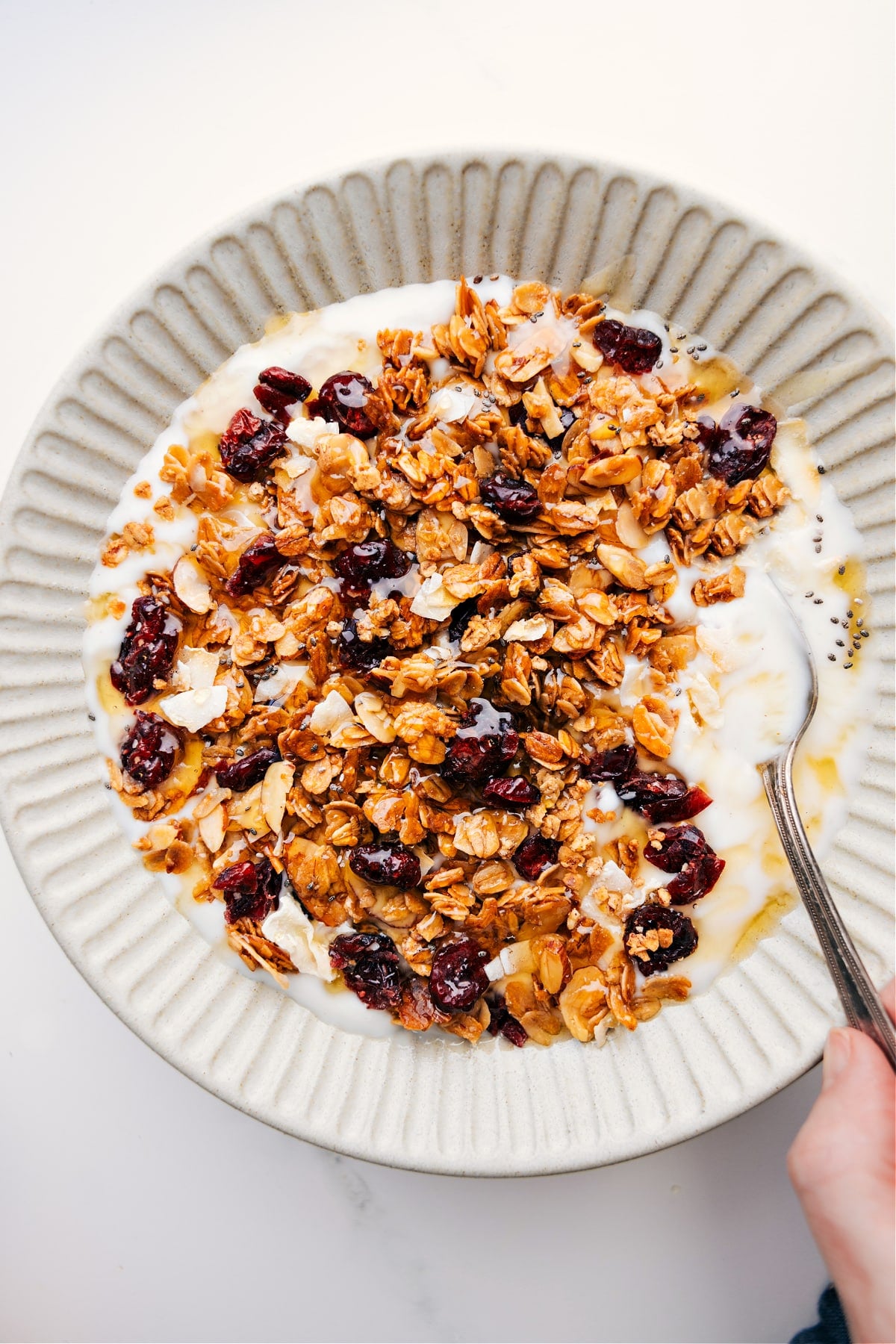 The Perfect Snack: Honey Almond Granola Honey Almond Granola sprinkled over yogurt with a drizzle of honey on top.