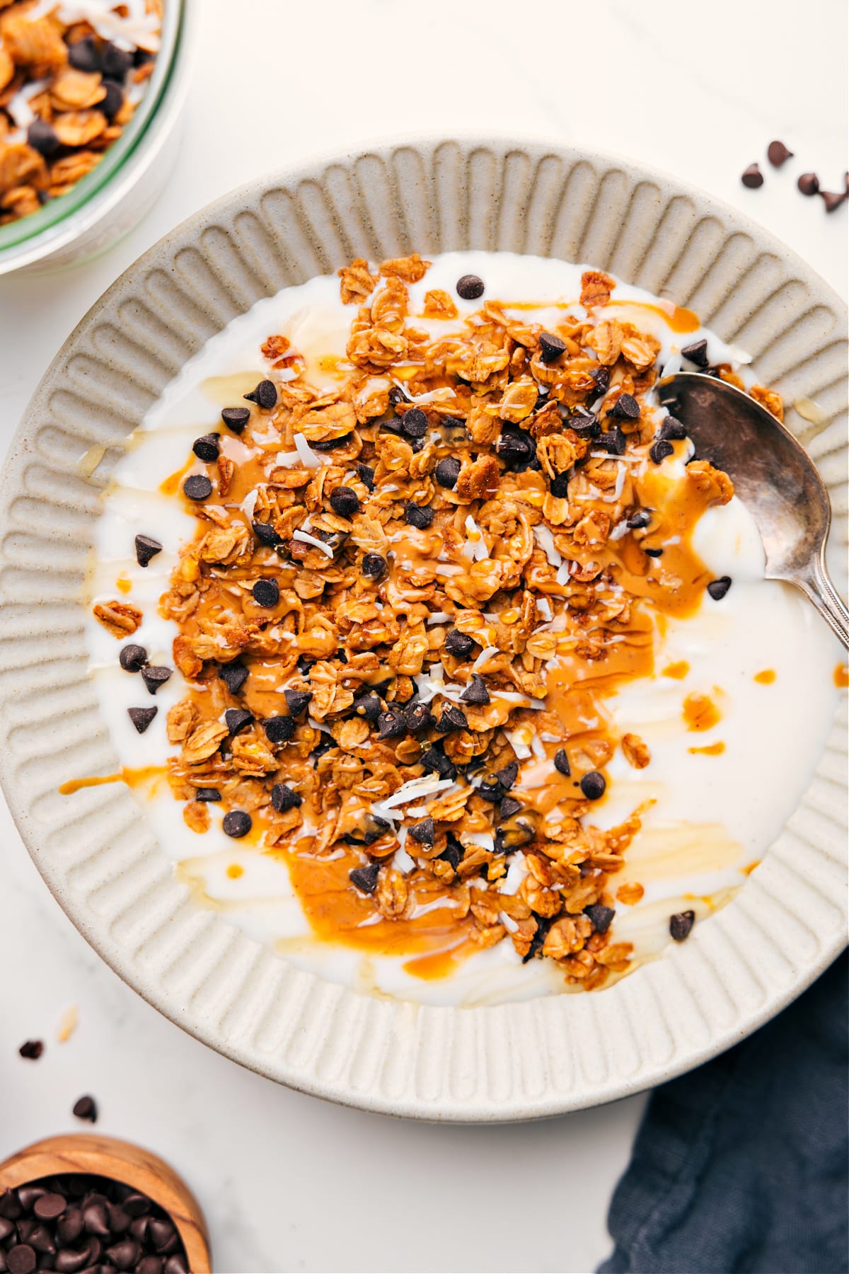 Peanut Butter Granola Recipe served over yogurt with a drizzle of honey on top.