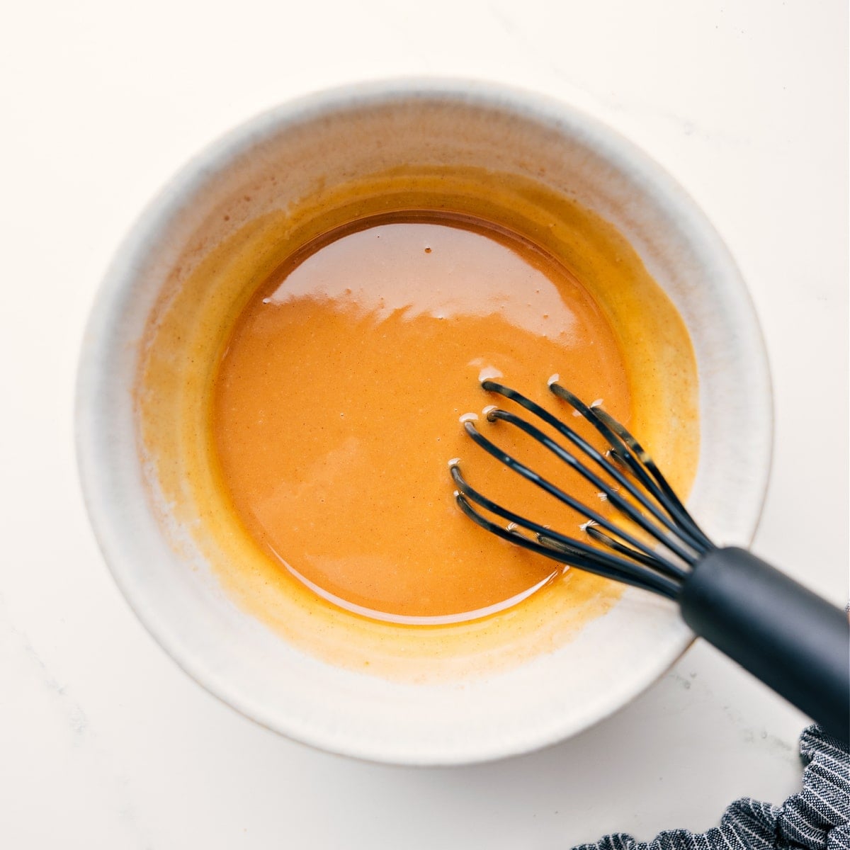 How To Make This Peanut Butter Granola Recipe Peanut butter, honey, coconut oil, vanilla, salt, and cinnamon whisked together in a large bowl for this peanut butter granola recipe.