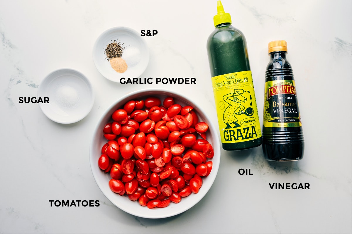 Ingredients In Roasted Cherry Tomatoes All the ingredients in this recipe prepped for easy assembly, including sugar, seasonings, tomatoes, olive oil, and vinegar.
