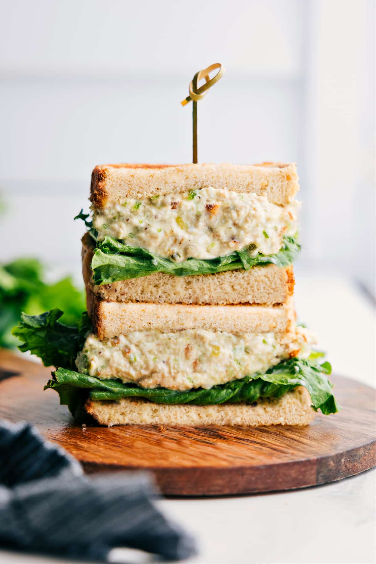 Chick-Fil-A Chicken Salad Recipe served in halved sandwich bread, stacked to show creamy chicken salad filling.