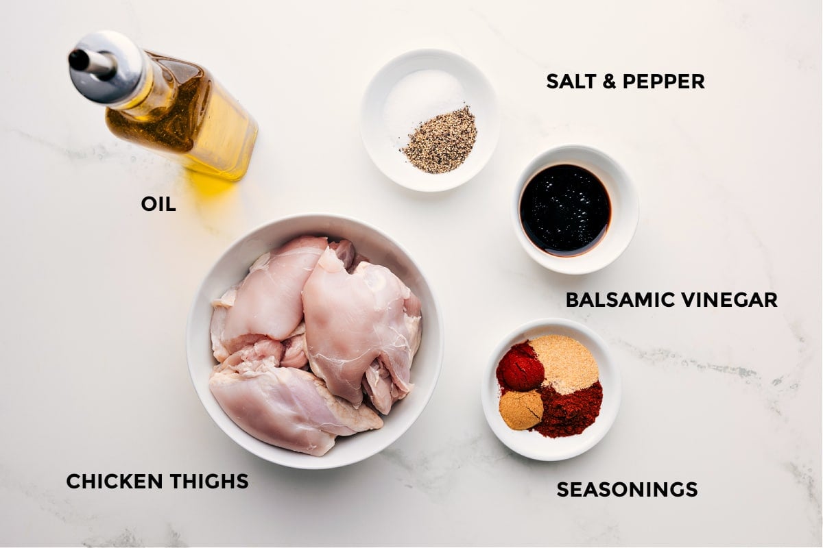 Ingredients In Baked Chicken Thighs All the ingredients in this recipe prepped out for easy assembly including the oil, thighs, seasonings, and balsamic vinegar.