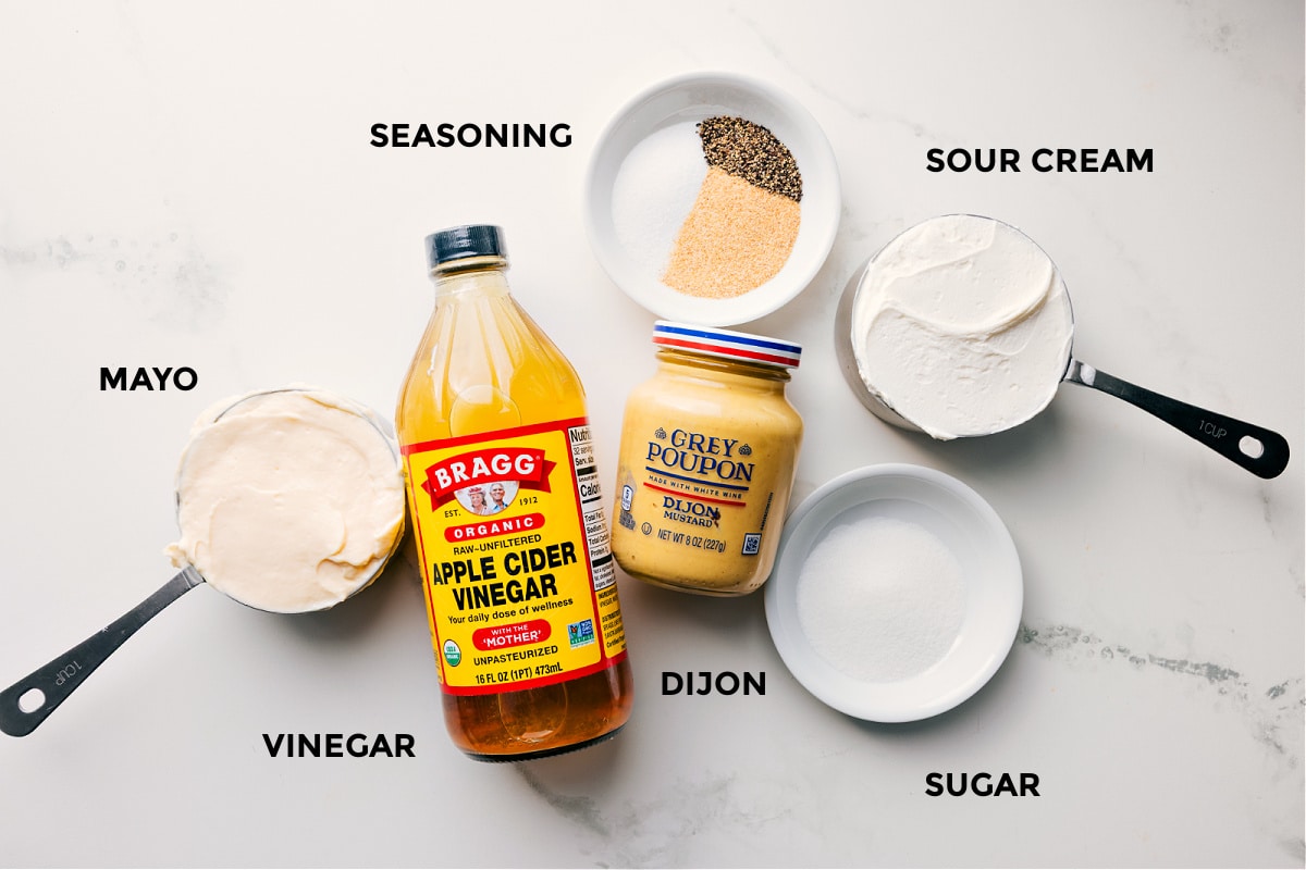 Ingredients In Chicken Macaroni Salad The dressing ingredients in this chicken macaroni salad prepped out for easy assembly including the mayo, vinegar, seasoning, sour cream, dijon, and sugar.