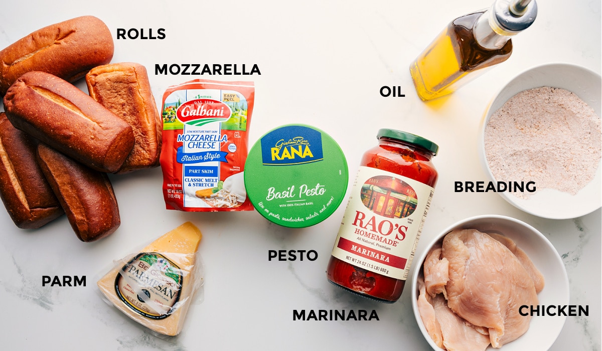 Ingredients In Chicken Parmesan Sandwich All the ingredients prepped and ready for easy assembly: rolls, mozzarella, parmesan, pesto, marinara, breading, oil, and chicken.