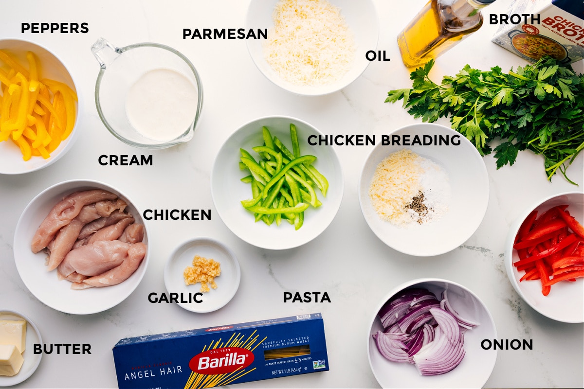 Ingredients In Chicken Scampi All Chicken Scampi ingredients prepped and ready for assembly: peppers, cream, chicken, butter, garlic, pasta, Parmesan, oil, onion, breading, broth, and parsley.