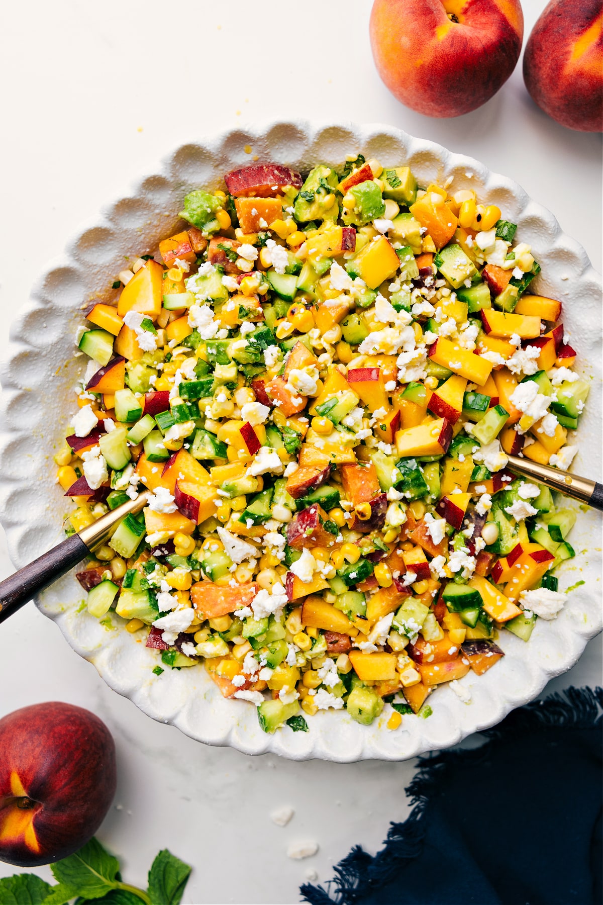 The Salad Of The Summer: Peach Feta Salad Peach feta salad tossed together in a bowl ready to be enjoyed.