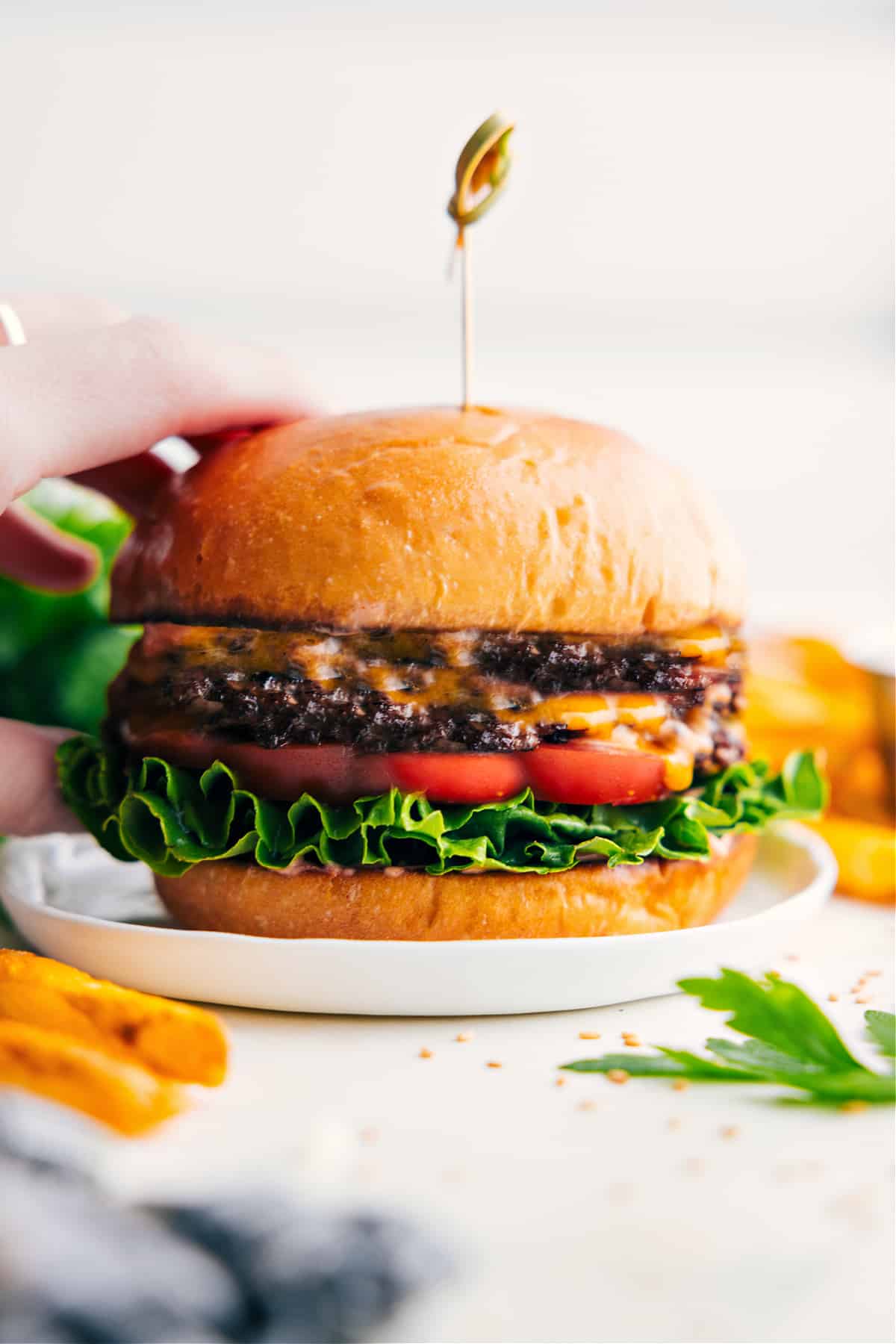 Smashburger recipe with lettuce, tomato, cheese, and special sauce in a toasted bun.
