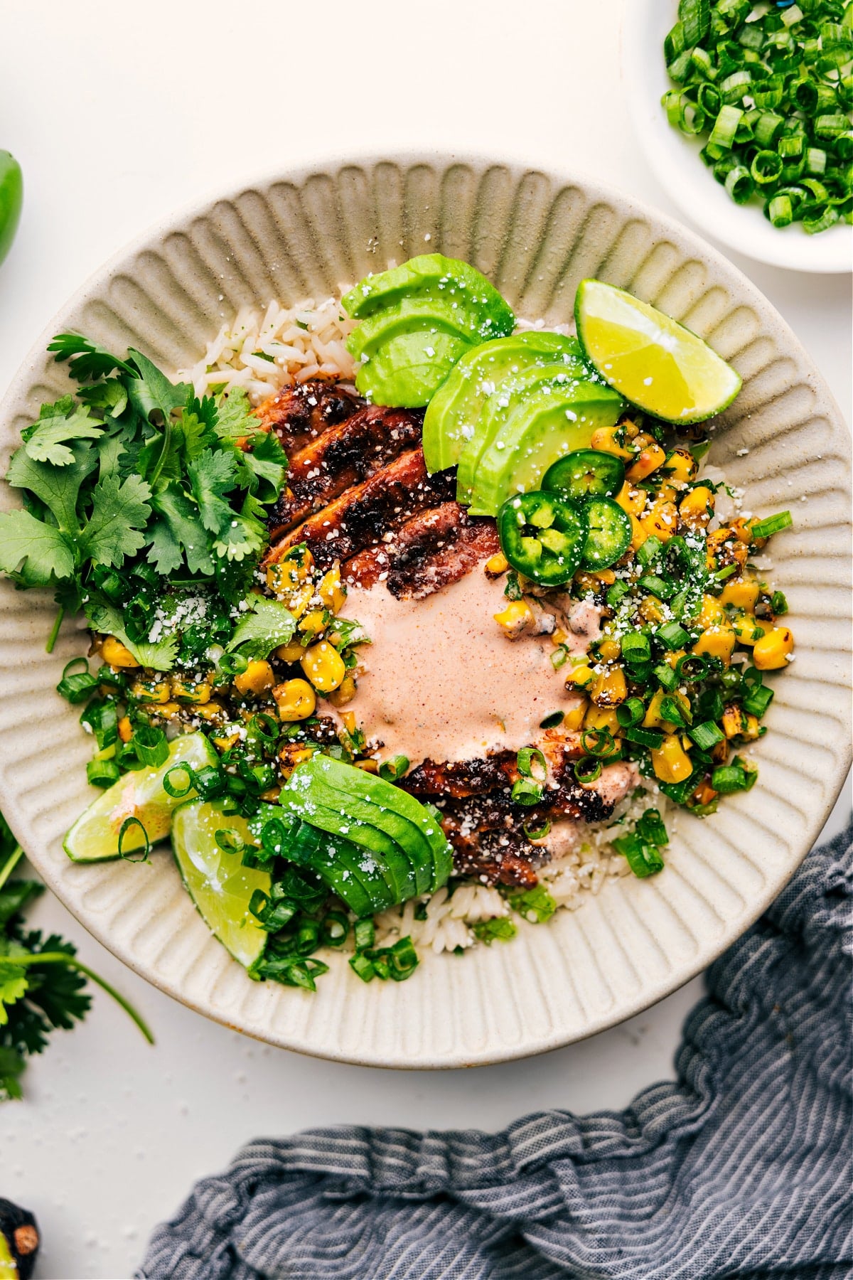 Street Corn Chicken Rice Bowl with avocado, cilantro, and creamy sauce.