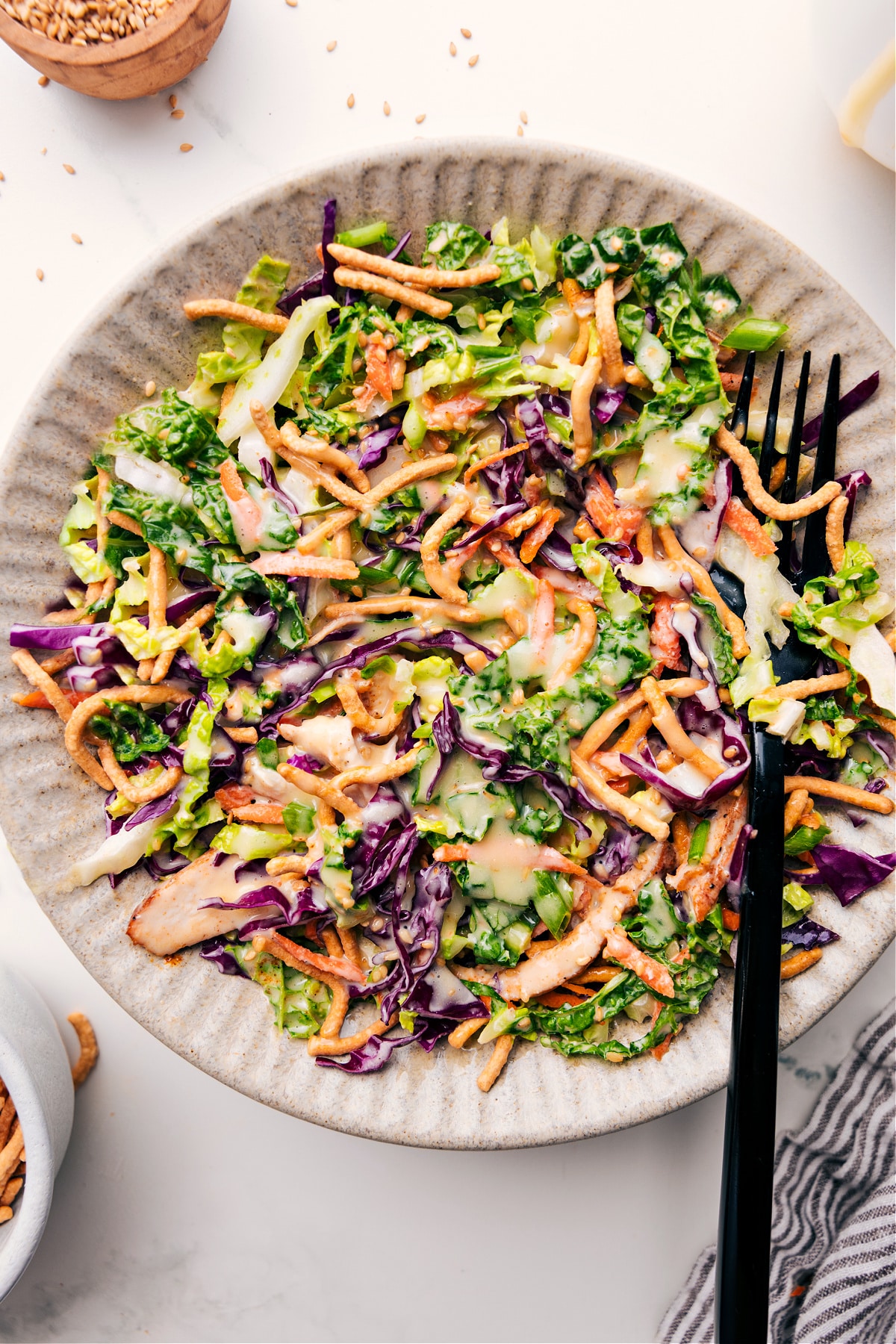 Asian Chicken Salad Recipe tossed with dressing in a bowl ready to be enjoyed.