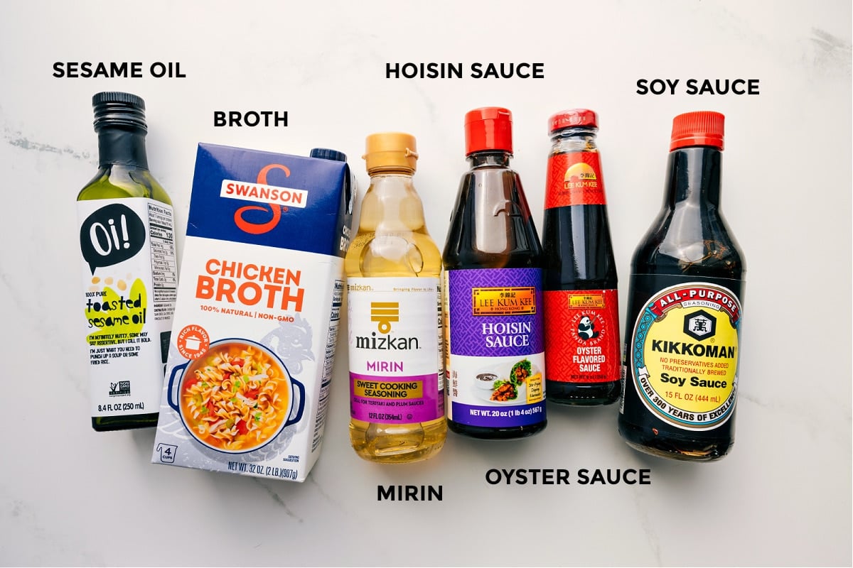 Ingredients In Beef Noodle Bowls The sauce ingredients prepped out for easy assembly including the sesame oil, broth, hoisin sauce, mirin, oyster sauce, and soy sauce.