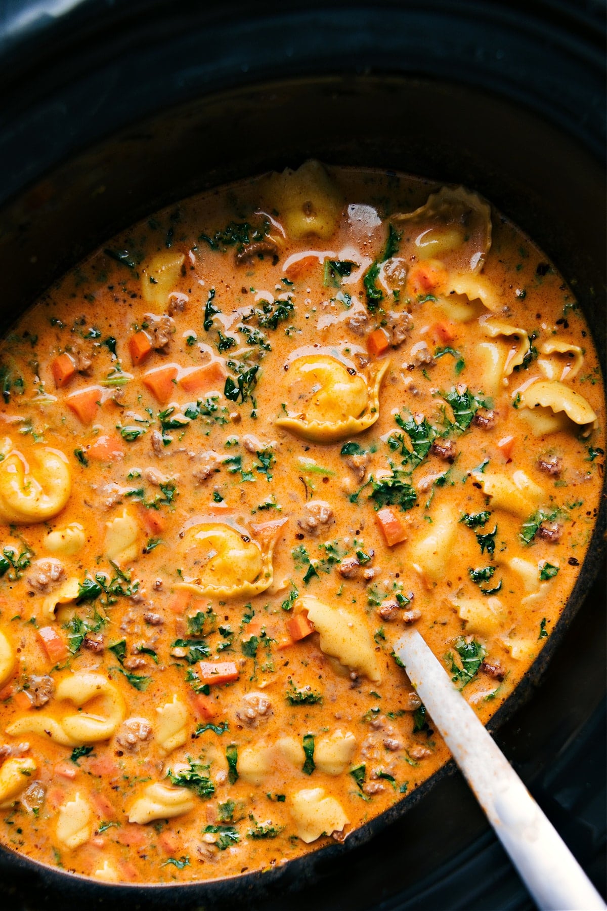 Crockpot Tortellini Soup in the slow cooker, hot and ready to serve.