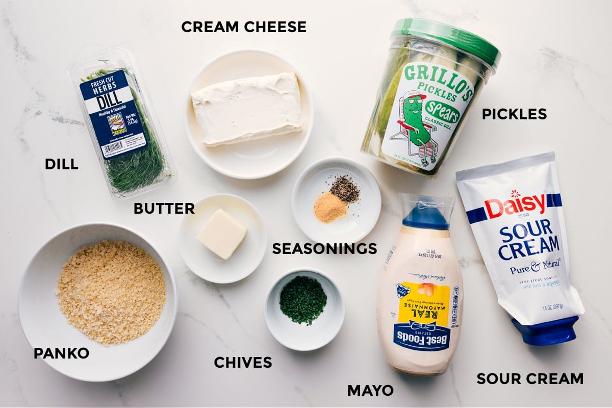 Ingredients In Fried Pickle Dip All ingredients prepped for easy assembly: dill, cream cheese, panko, butter, seasonings, chives, mayo, sour cream, and pickles.
