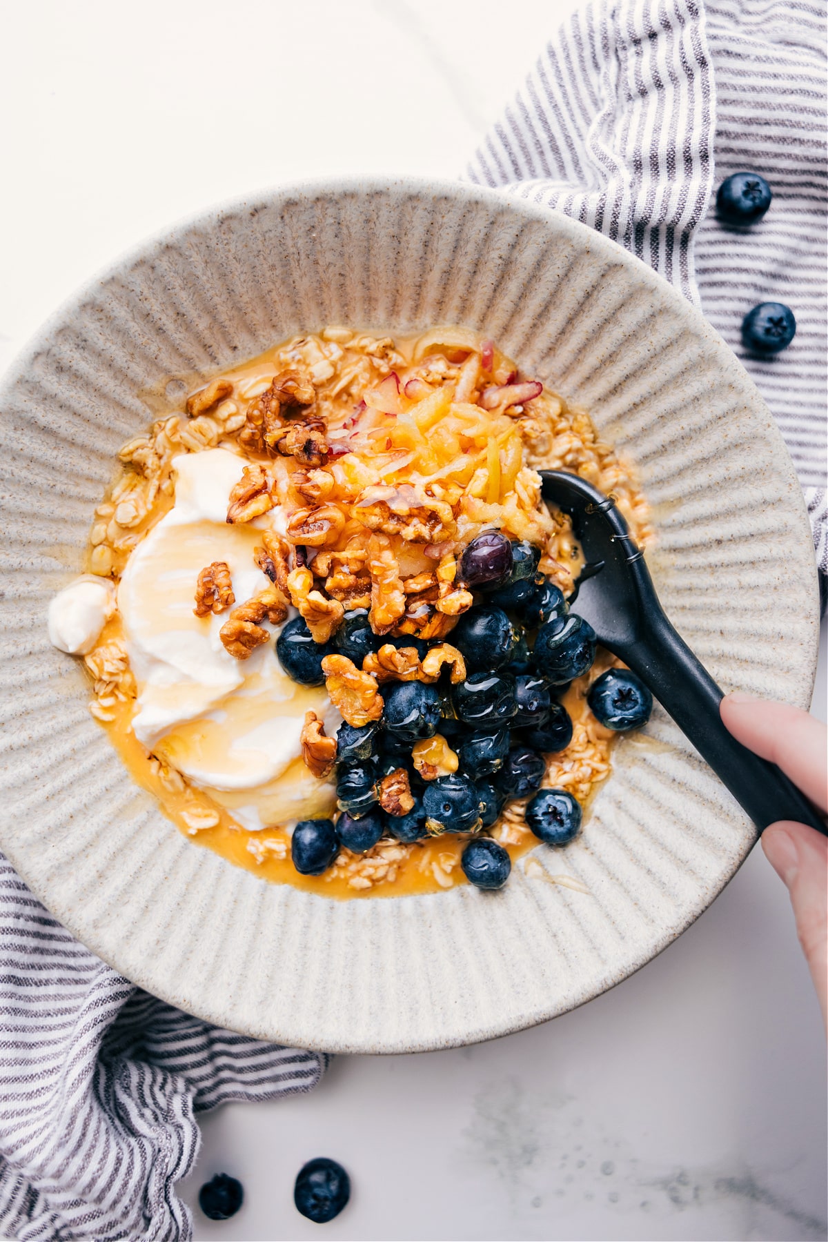Princess Diana's Breakfast in a bowl with blueberries, walnuts, and yogurt on top, ready to enjoy.