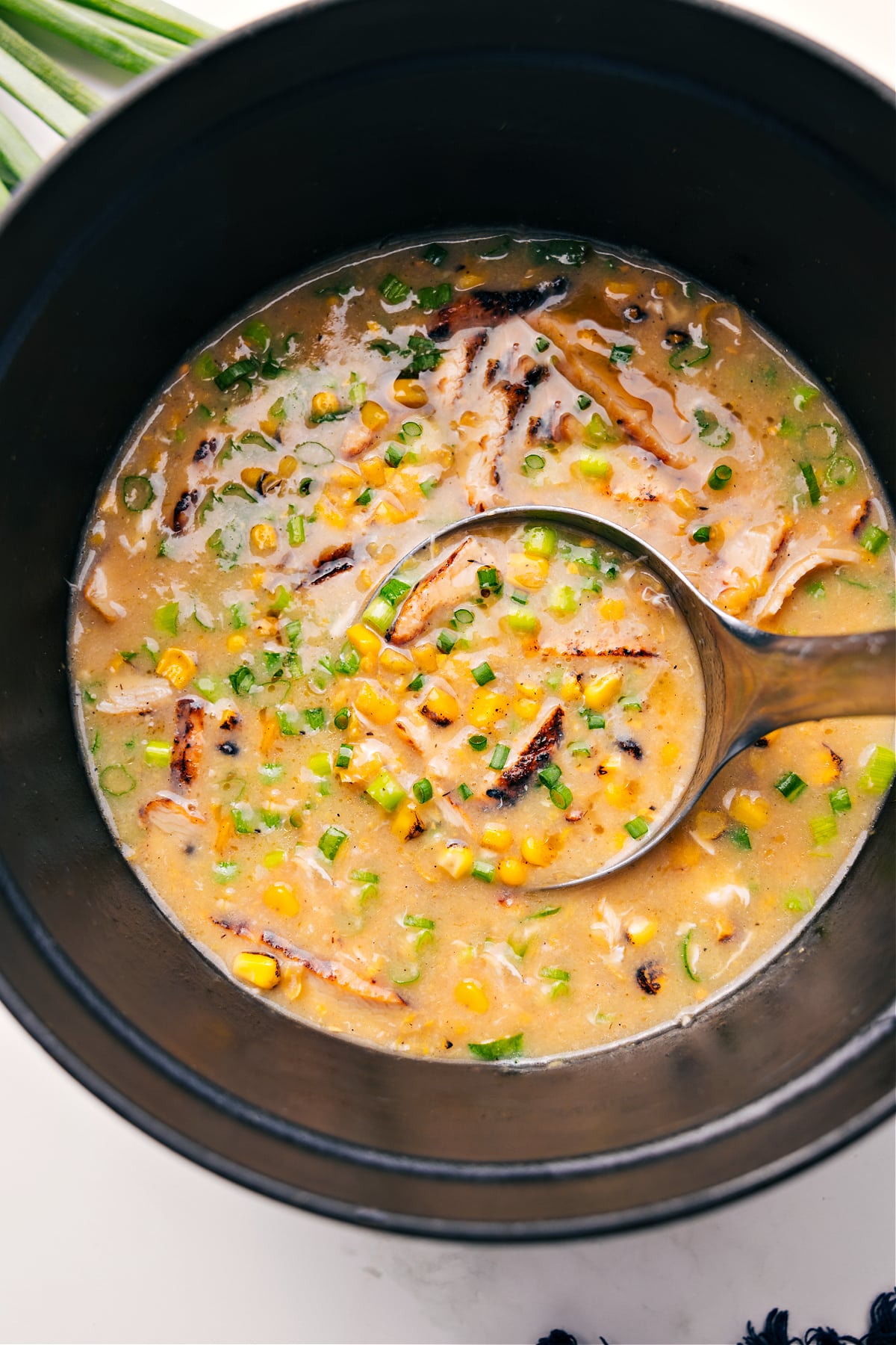 Chicken Corn Soup Recipe in a pot with a ladle scooping some out.