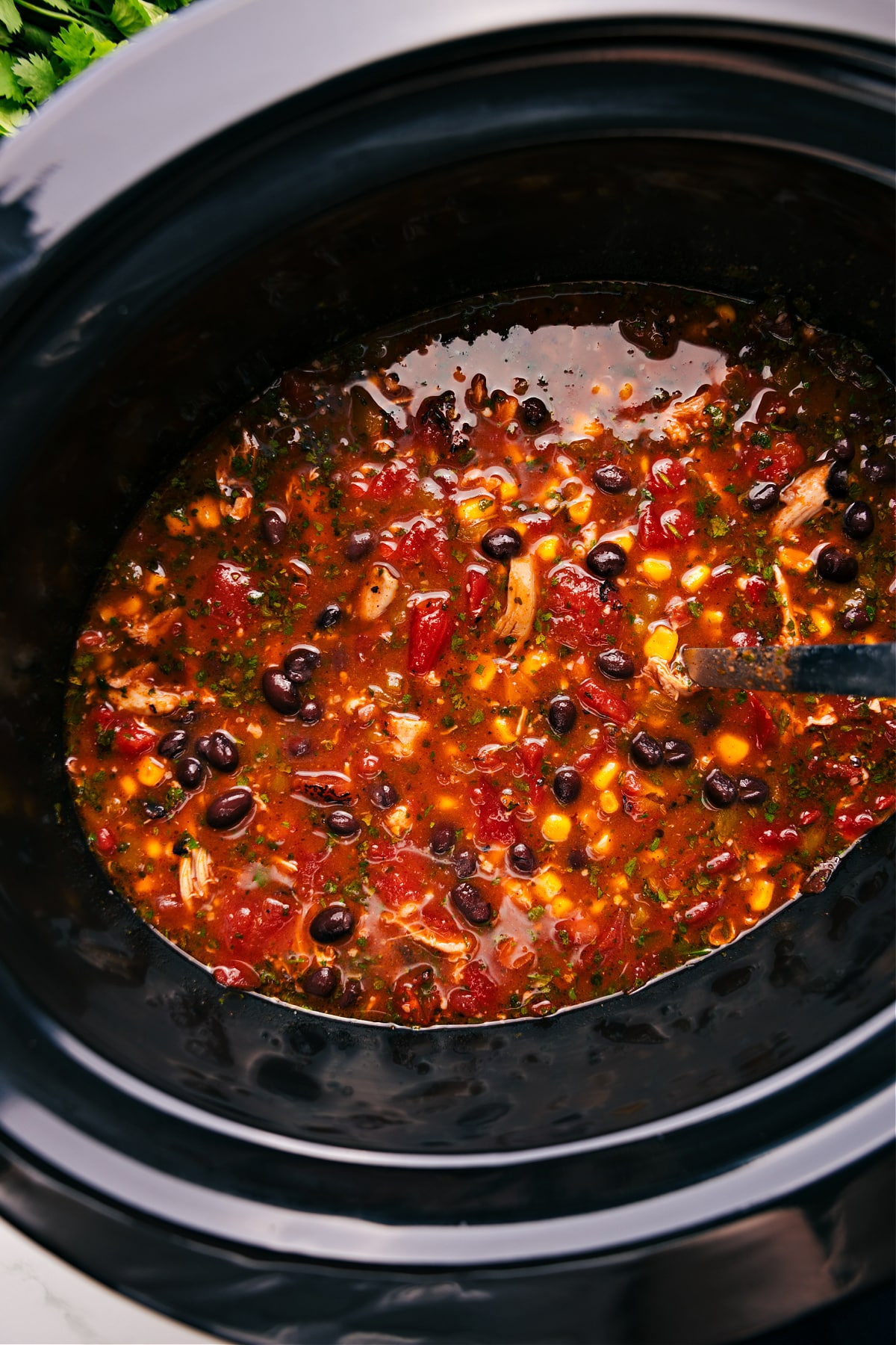 Chicken Taco Soup in the slow cooker, hot and ready to be enjoyed.