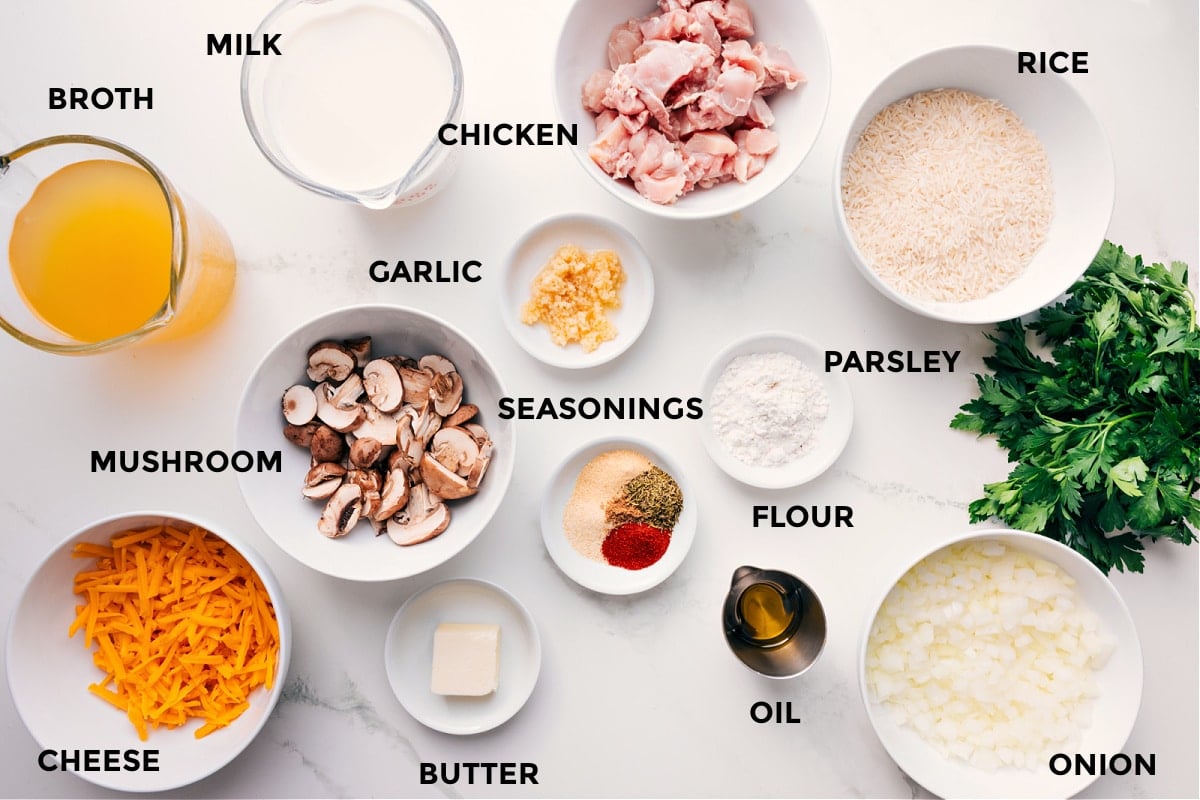 Ingredients In Smothered Chicken And Rice All the ingredients in this recipe prepped out for easy assembly including the broth, mushroom, milk, chicken, garlic, seasonings, flour, parsley, rice, oil, butter, carrots, and onion.