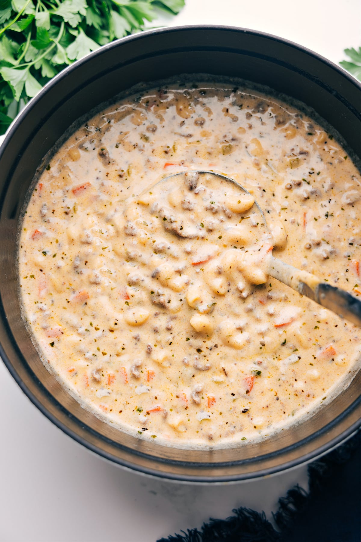 Cheeseburger Macaroni Soup simmering in a pot, ready to be ladled and enjoyed.