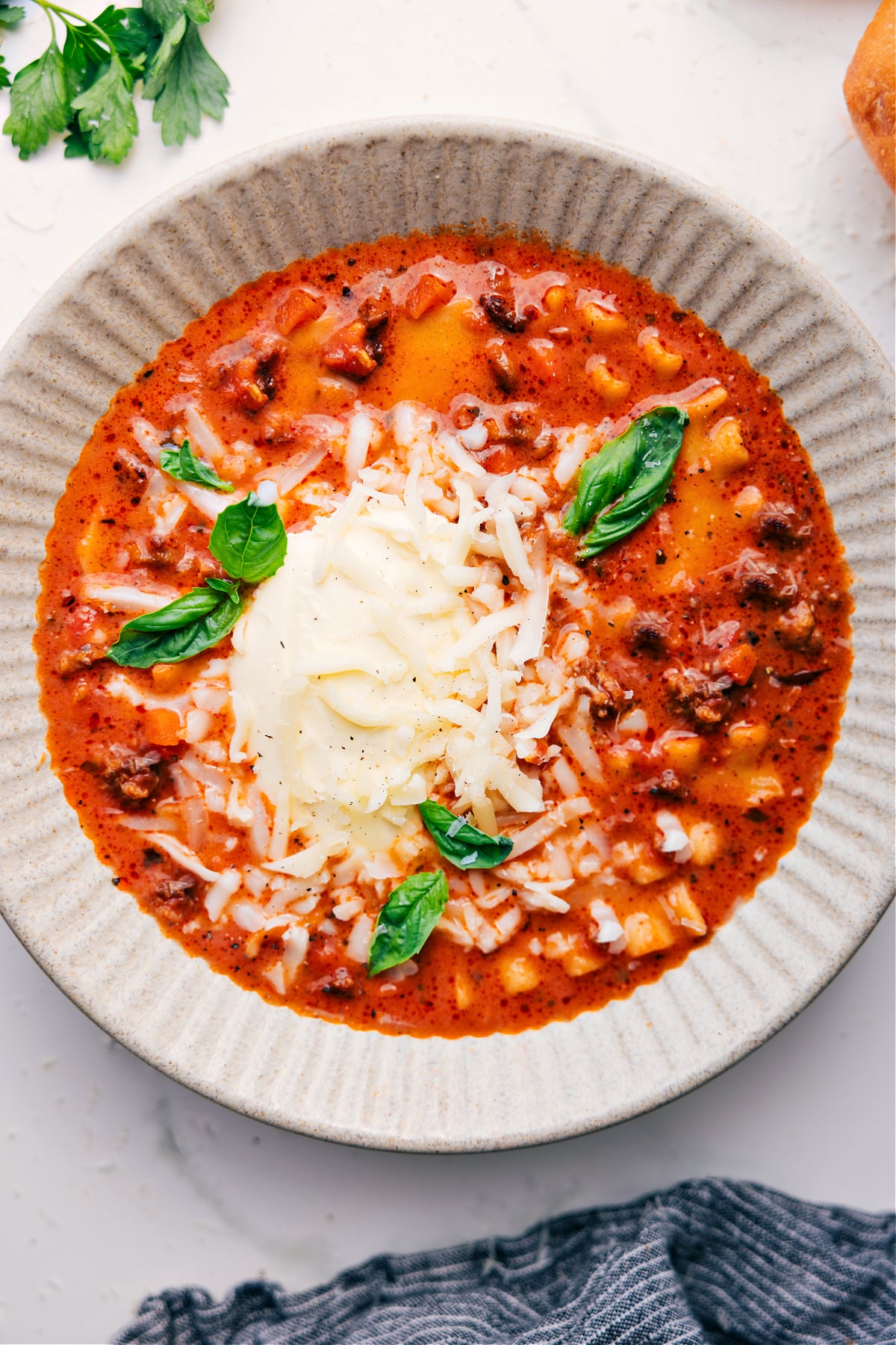 Pure Comfort Food: Crockpot Lasagna Soup A bowl of the dish topped with freshly grated cheese and basil, ready to be enjoyed.