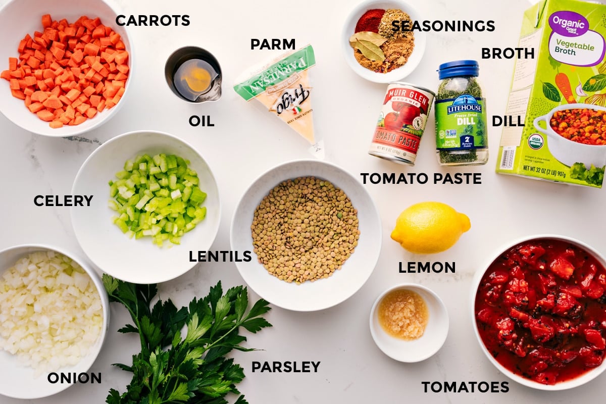 Ingredients In Mediterranean Lentil Soup All the ingredients prepped and ready for easy assembly, including carrots, celery, onion, lentils, parsley, garlic, tomatoes, lemon, seasonings, tomato paste, dill, and broth.