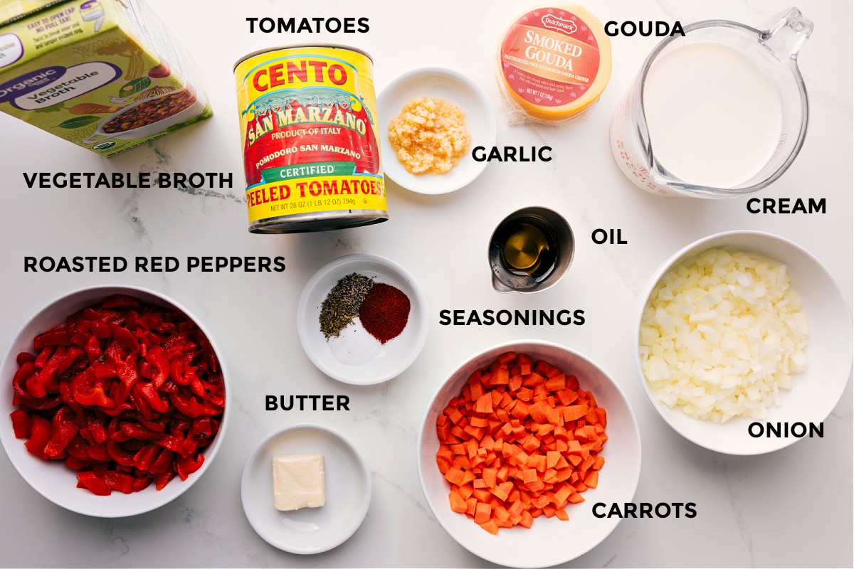 Ingredients In Roasted Red Pepper Gouda Soup All the ingredients int his recipe prepped out for easy assembly including the broth, red peppers, tomatoes, seasonings, butter, oil, garlic, gouda, cream, onion, and carrots.